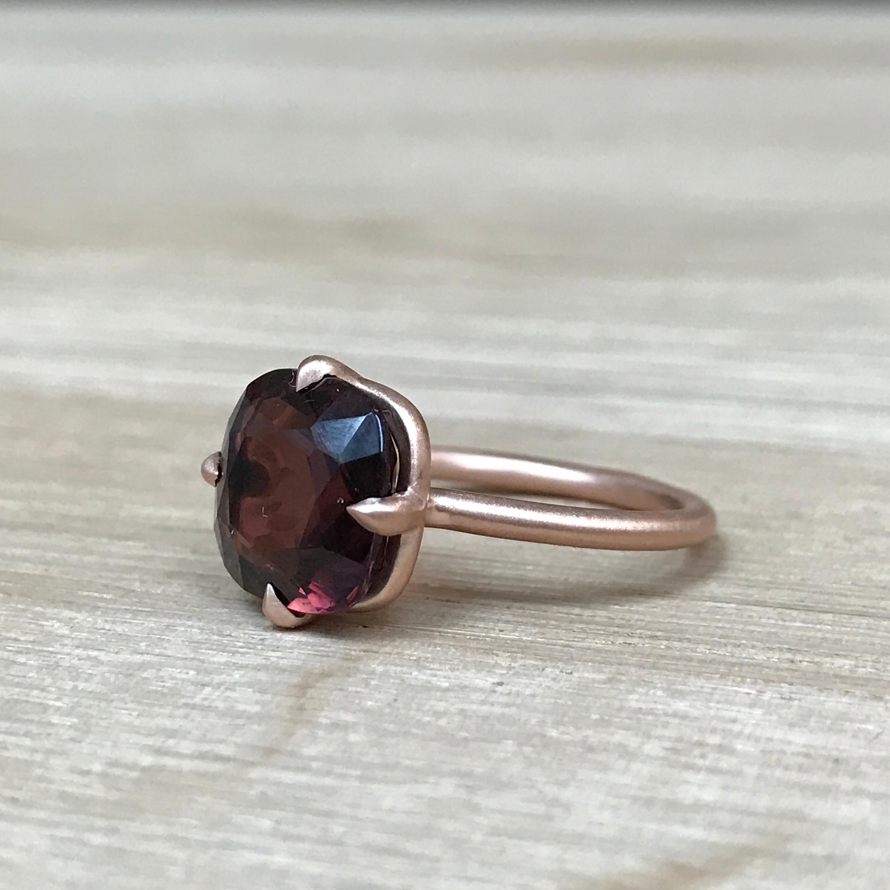 This 4.42 carat tourmaline ring is a unique cherry wine color that catches the light perfectly. The setting was carefully designed by Finn to enhance the shape of the stone and the use of satin finished rose gold highlights the natural earthy