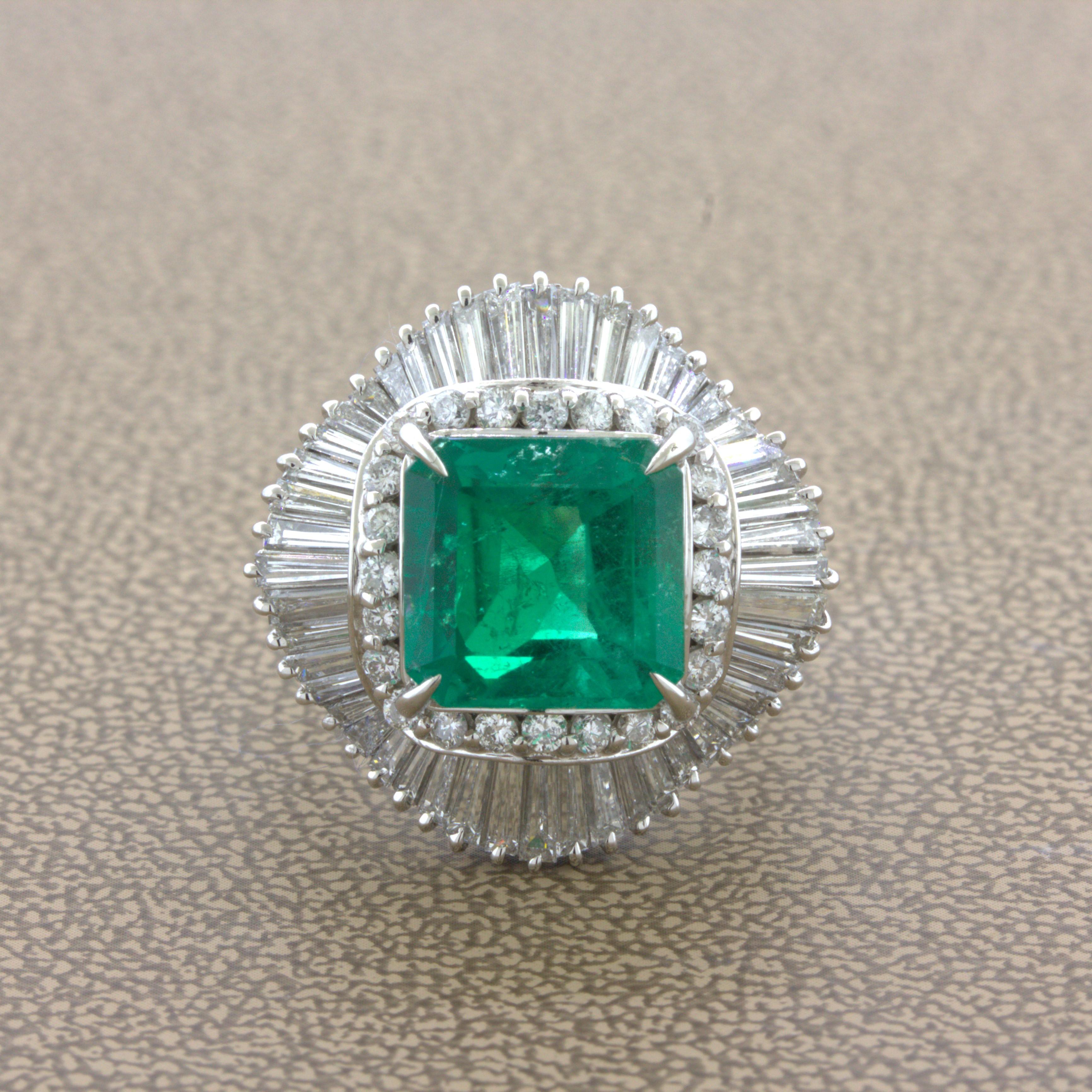 A fine Colombian emerald weighing 4.42 carats takes center stage of this platinum ballerina ring. The emerald has the classic emerald-cut as well as an intense vivid green color only seen in top-quality stones. Adding to that, the emerald is