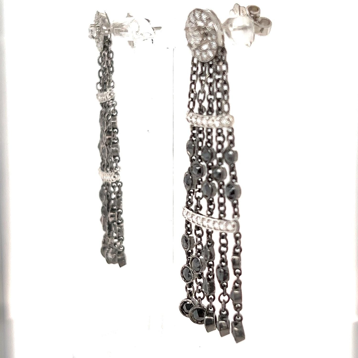These long earrings have Natural Black Rose Cut Diamonds that weigh 3.00 Carats and Natural White Round Cut Diamonds that weigh 1.43 Carats. The total carat weight of the earrings are 4.43 Carats.  The clarity and color of the white diamonds are