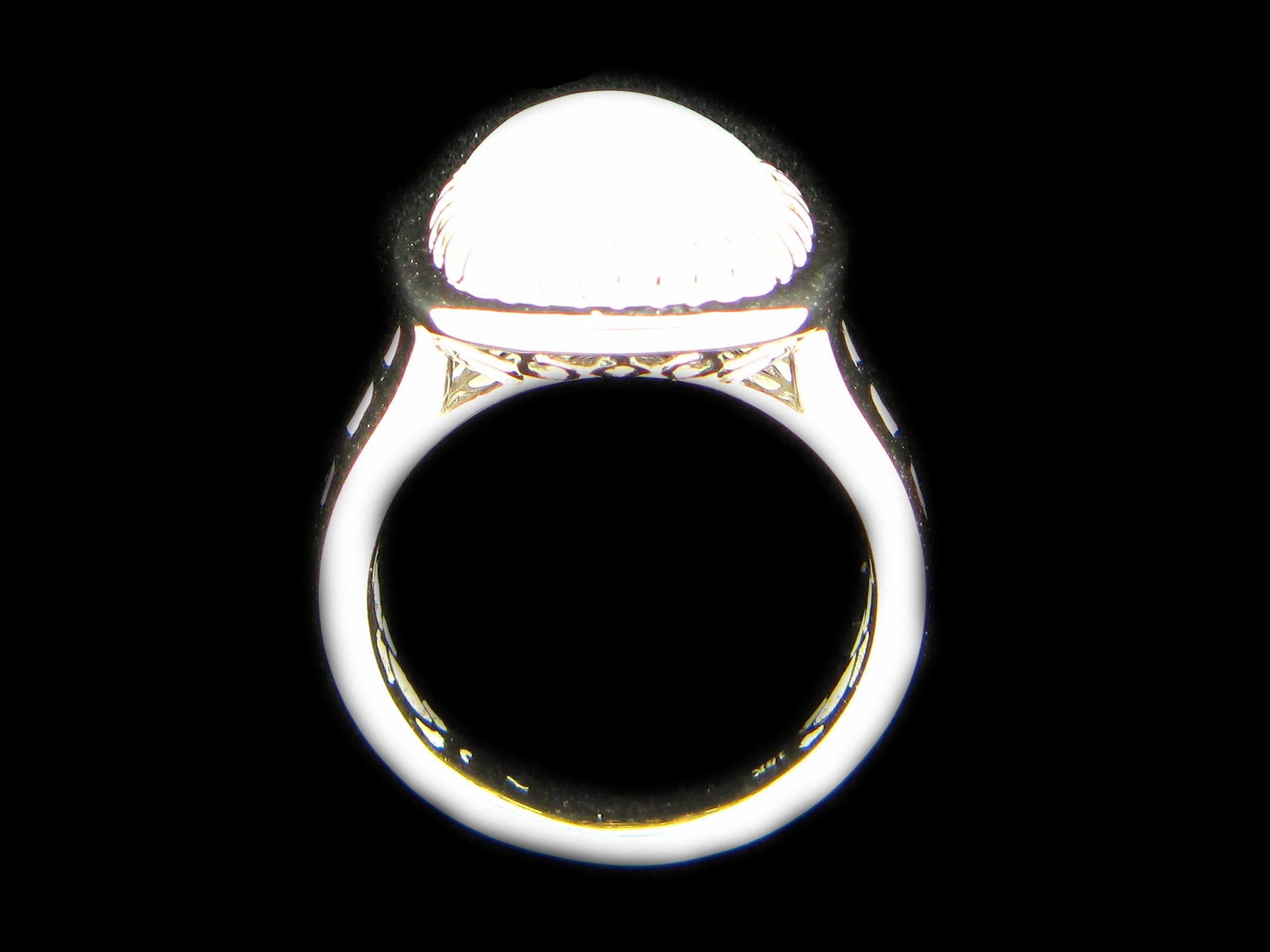 This stunning cocktail ring showcases a beautiful 4.43 carat Cushion Opal flanked on each side by a set of 3 baguette white diamond set in 18 karat white gold. 

Total diamond weight (not including center stone) = 0.17 carats. Ring size is 6 1/2.
