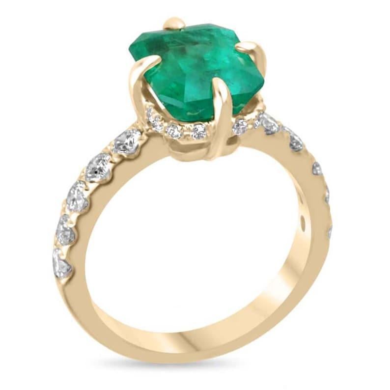 Presenting a bespoke Colombian emerald solitaire with accent diamonds, featuring a mesmerizing classic-cut Muzo emerald, elegantly set in 18K yellow gold. This masterpiece showcases a 3.75-carat emerald, glowing with the rich, deep green hue