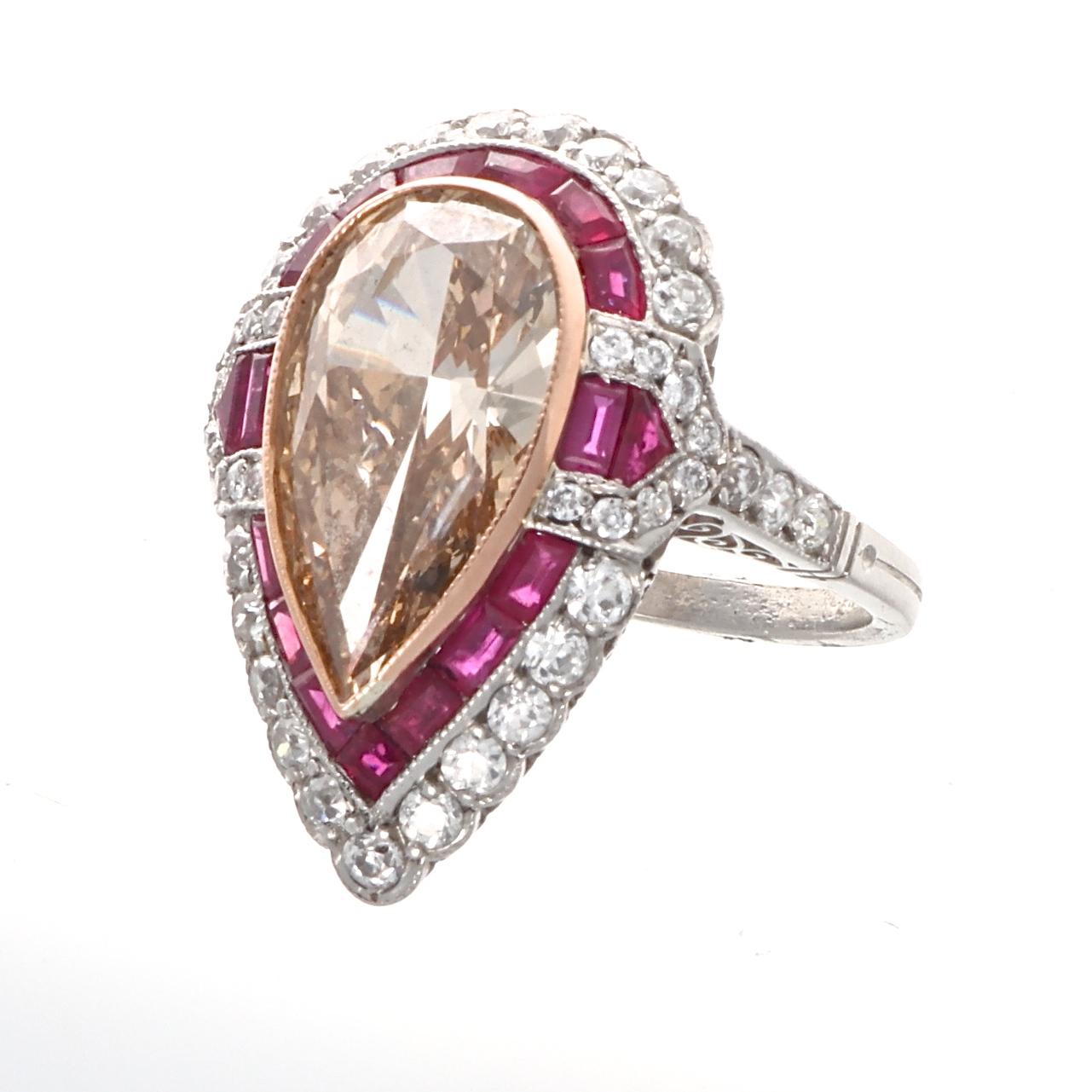 Pure artistry in using gemstones as the paintbrush and the ring as palette. Featuring a 4.44 carat natural fancy brownish-orange pear shaped diamond geometrically outlined by vibrant red rubies and numerous near colorless diamonds. Crafted in