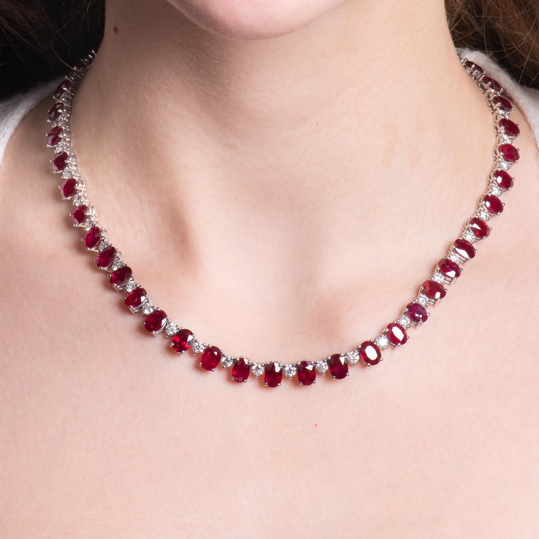 This exquisite necklace features 44.49ct total weight in oval rubies that go around the full 18 inches of the necklace, bordered by 6.90ct total weight in round diamonds. The rubies are lively, of medium saturation, and matched beautifully. The