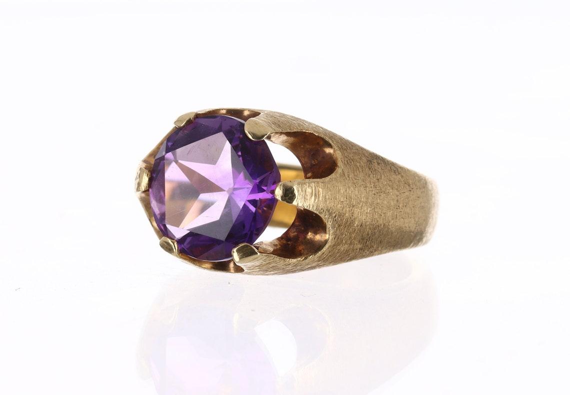 Feast your eyes on this incredible 4.44-carat natural, round-cut amethyst. This gemstone showcases excellent luster, and eye clarity followed along with its gorgeous intense purple color. It is perfectly set into a 14K yellow gold prong setting,