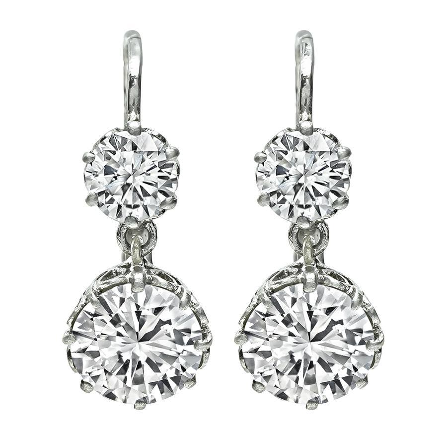 This is a gorgeous pair of platinum earrings. The earrings feature 2 large sparkling round cut diamonds that weigh approximately 2.38ct. The color of the diamonds is J-K with VS clarity. The large diamonds are accentuated by 2 dazzling small round