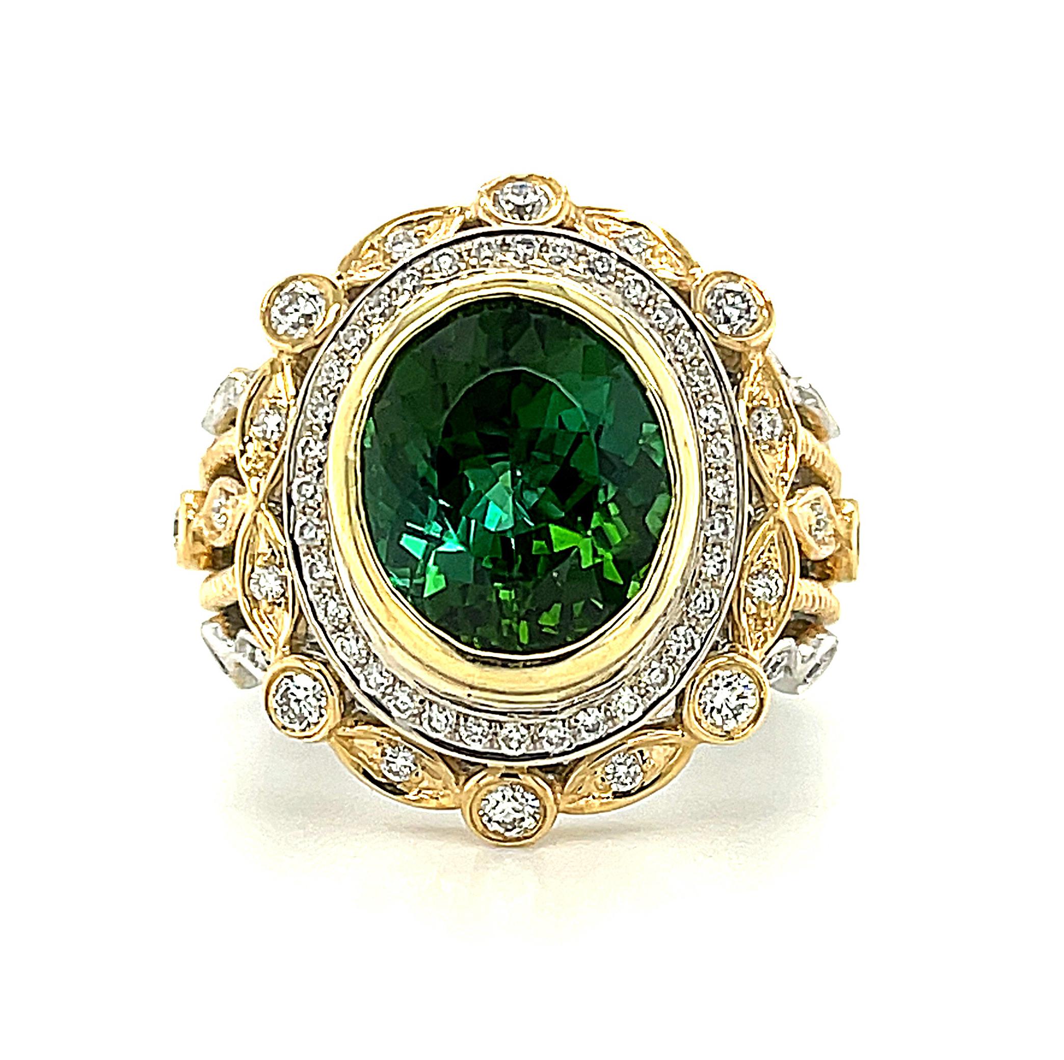 This spectacular ring is a new crown jewel for your collection! The 4.45 carat oval green tourmaline is a vibrant green color that is alive with unusual brilliance and gorgeous blue flashes. Framed by a halo of white diamonds and an elaborate design