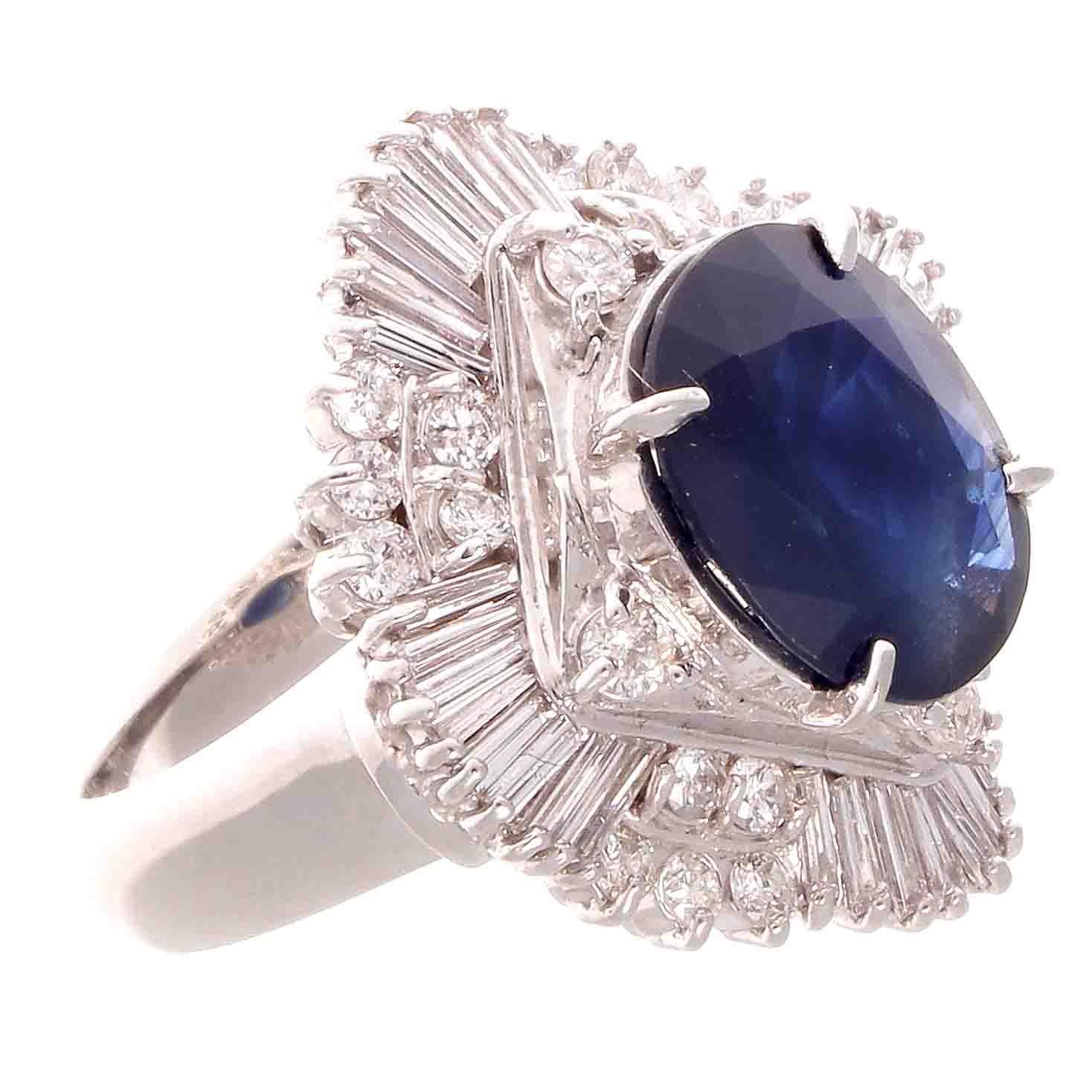 A superb sapphire diamond ring that sparkles and is full of life. Featuring a 4.45 carat navy blue sapphire accented by a spray of 1.81 carats of baguette and round cut colorless diamonds. Crafted in platinum.

Ring size 6 and can easily be resized,