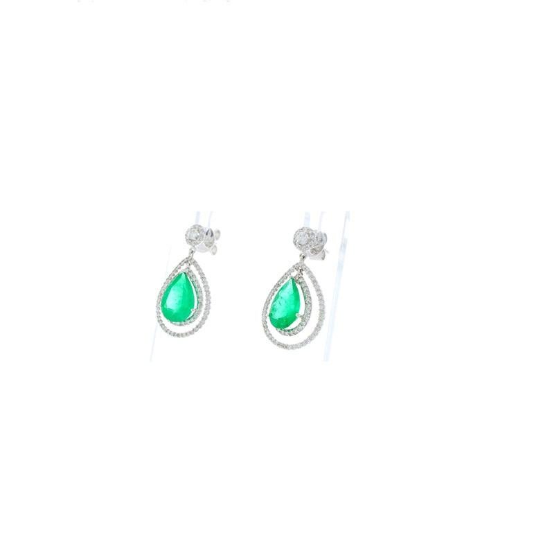 Gorgeous 4.45 carat total mint green, pear cut emeralds sit front and center of these spectacular earrings. The emeralds are vivid and perfectly matched, originating from Zambia. The quality is gem-quality providing excellent luster. The gemstones