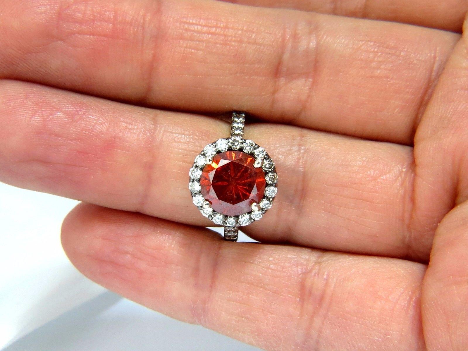 The Vivid Orange Red.

3.45ct. round brilliant natural diamond ring.

Center Diamonds has been coated Orange Red Color.

Round, Full cut brilliant

No Further enhancements.

I-1 Clarity.

9.65mm diameter.



Side Round Diamonds:

Natural Fancy