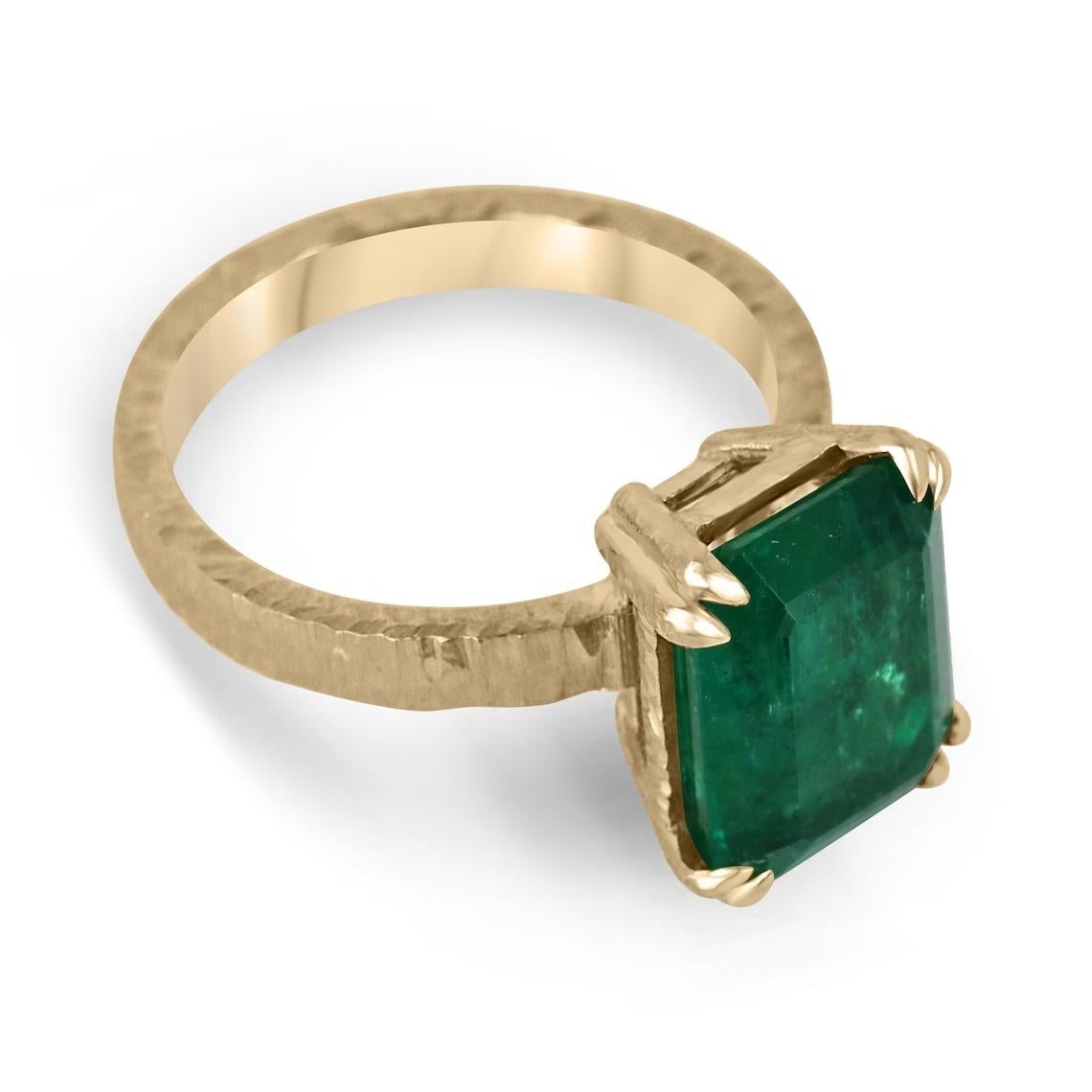 This 4.45-carat natural emerald cut emerald from Zambia is a showstopper. The emerald is cut in a classic emerald cut style, which shows off the stone's clarity and depth of color. The emerald is set in a unique four-double claw prong setting, which