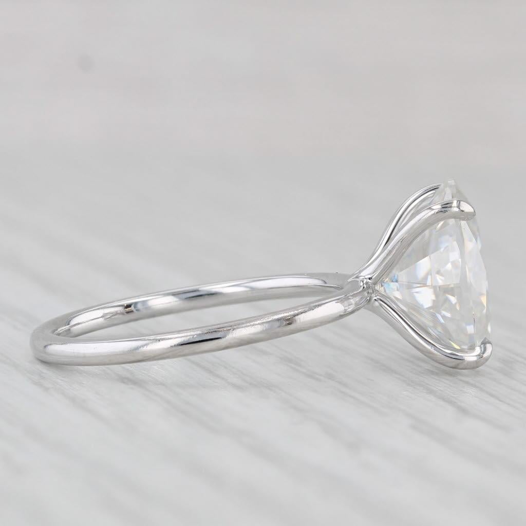 Gemstone Information:
- Natural Moissanite -
Carats - 4.45ct (8 x 12.1 mm) 
Cut - Oval Brilliant
Color - White / Colorless

Metal: 14k White Gold
Weight: 3.2 Grams 
Stamps: 14k
Face Height: 12 mm 
Rise Above Finger: 9.1 mm
Band / Shank Width: 1.6