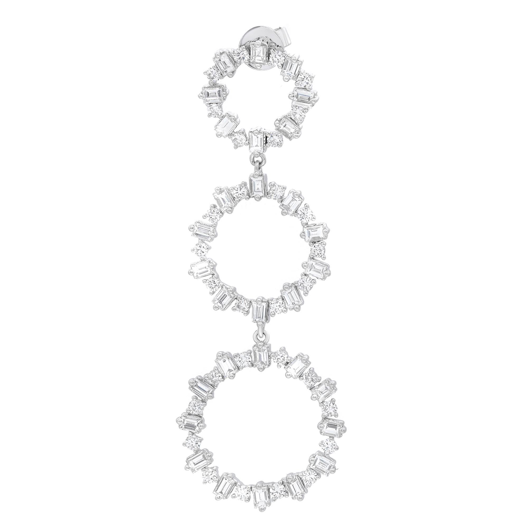 These exemplary dangle earrings mounted in 18k white gold add a touch of elegance and sophistication to any outfit. Featuring, prong set baguette and round cut diamonds encrusted in three graduating circles. Total diamond weight: 4.45 carats.