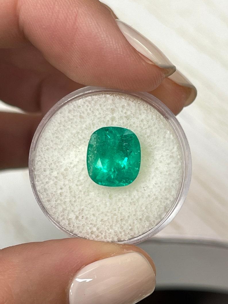 Stone: Emerald
Weight: 4.46-carats
Shape: Cushion Cut
Clarity: Semi-Transparent
Luster: Very Good
Color: Medium Green
Measurements: 10.62mm x 9.55mm x 7.30mm
Geographic Origin: Colombia
Treatment: Natural, Moderate Oil, Resin

Comments: Due to their