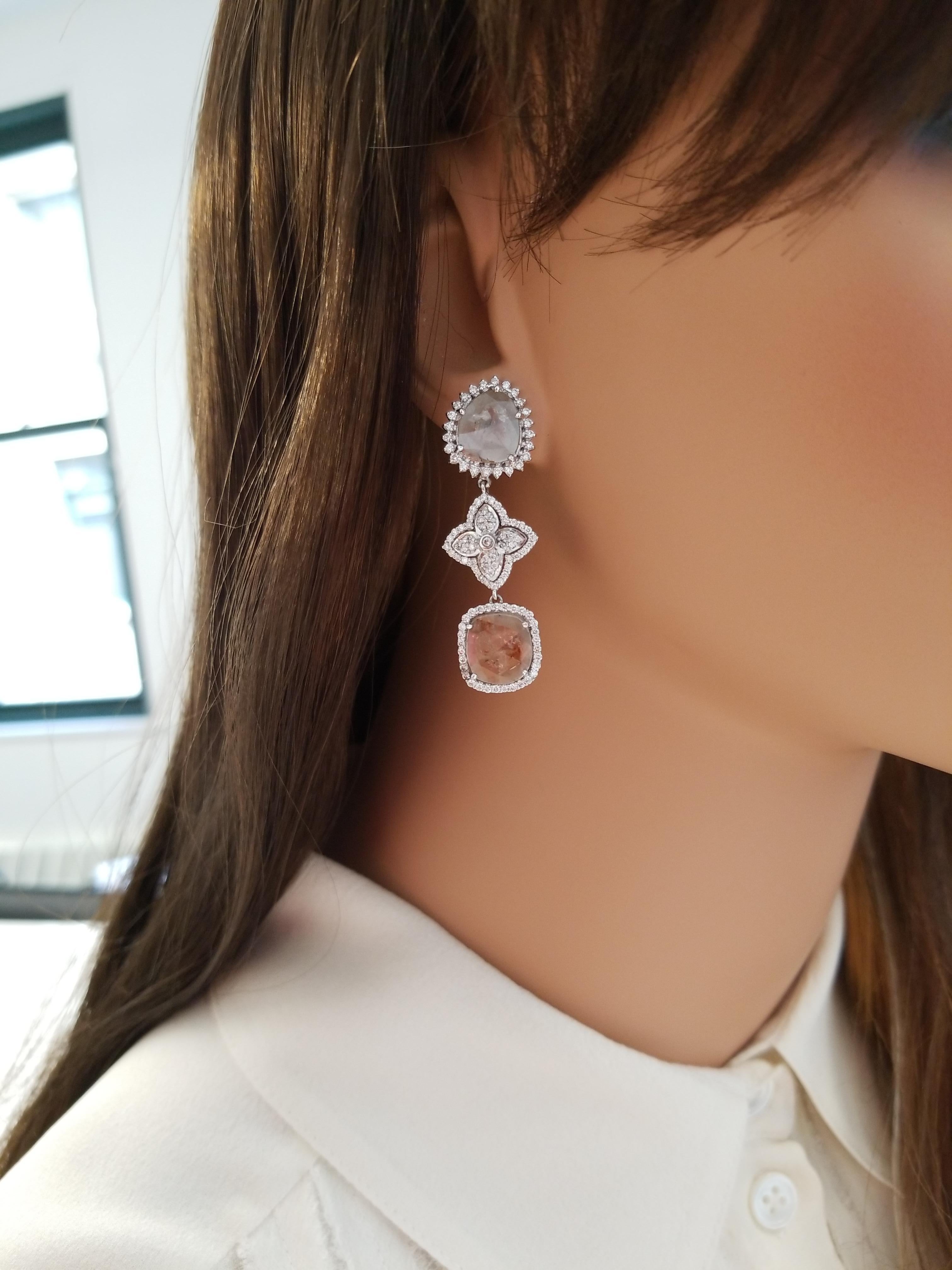 These are dangle earrings with 4 shimmering faceted fancy sliced diamonds totaling 4.46 carats. These diamonds are framed by sparkling round brilliant cut white diamonds, prong set, around each one in a dazzling halo totaling 1.33 carats. Designed