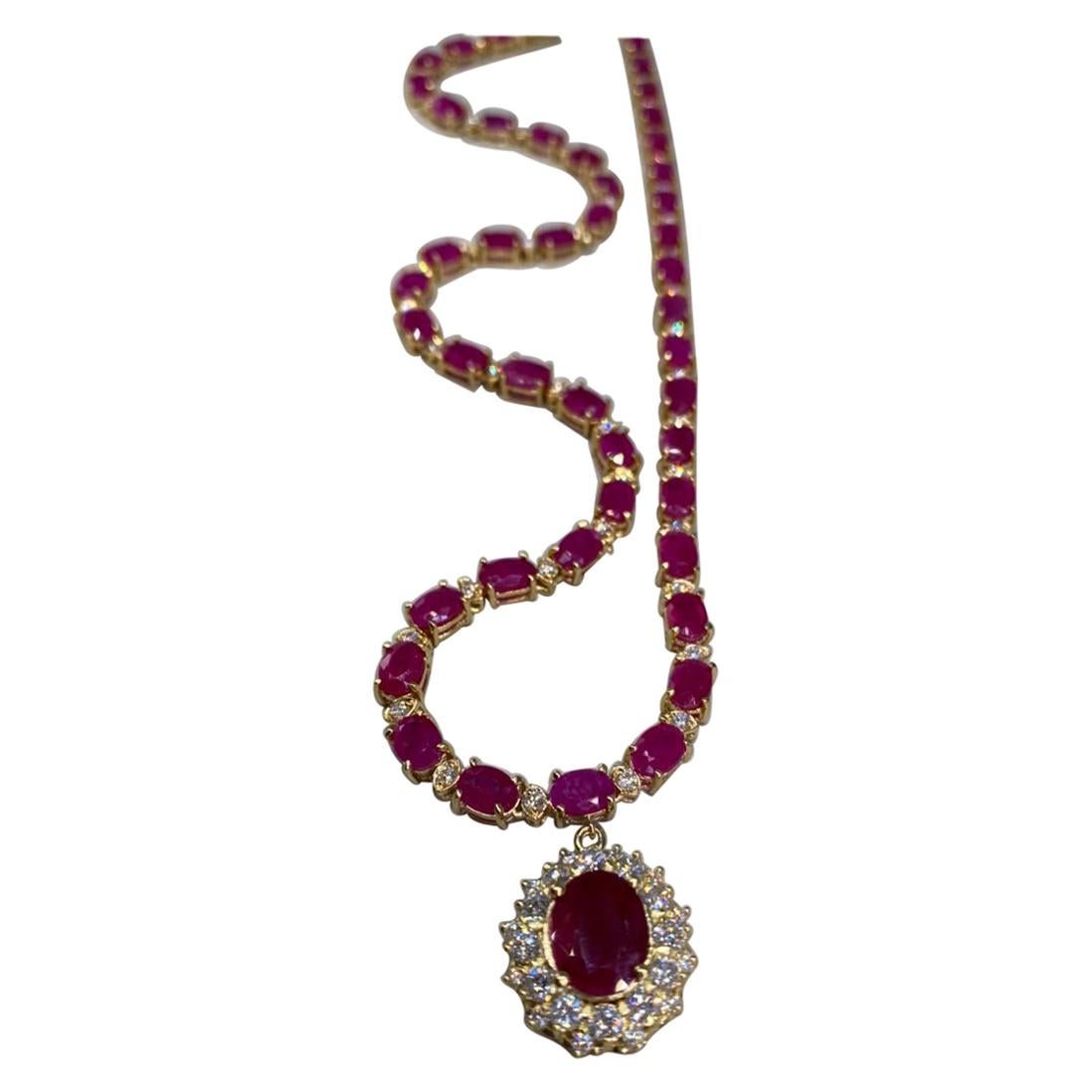 44.60 CTW Ruby 18K Yellow Gold Diamond necklace

Stamped: 18K
Total Necklace Weight: 28.7 Grams
Necklace Length: 18.5 Inches
Center Ruby Weight: 3.50 Carat (10.00x8.00 Millimeters)
Side Ruby Weight: 38.90 (7.00x5.00 Millimeters)
Diamond Weight: 2.20