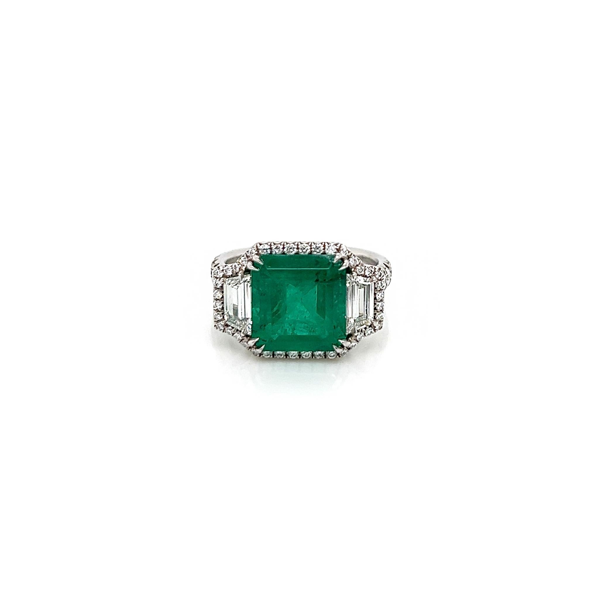 4.46 Total Carat Emerald and Diamond Halo Ladies Ring. GIA Certified.

-Metal Type: Platinum
-3.91 Carat Cut Natural Colombian Beryl Emerald, GIA Certified 
-Emerald Color: Green
-0.55 Carat Round and Trapezoid Natural side Diamonds. 
      ~Round