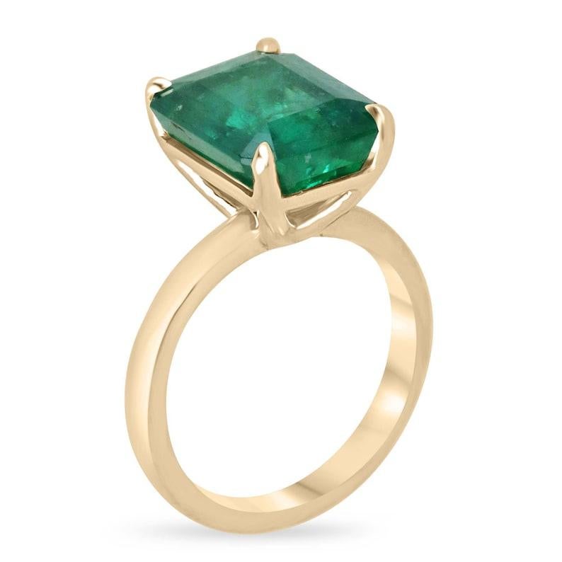 Unveil timeless sophistication with our distinguished solitaire emerald ring, boasting a captivating 4.46-carat emerald cut emerald elegantly set north to south. Revel in the emerald's enchanting rich green hue and semi-transparent clarity, exuding