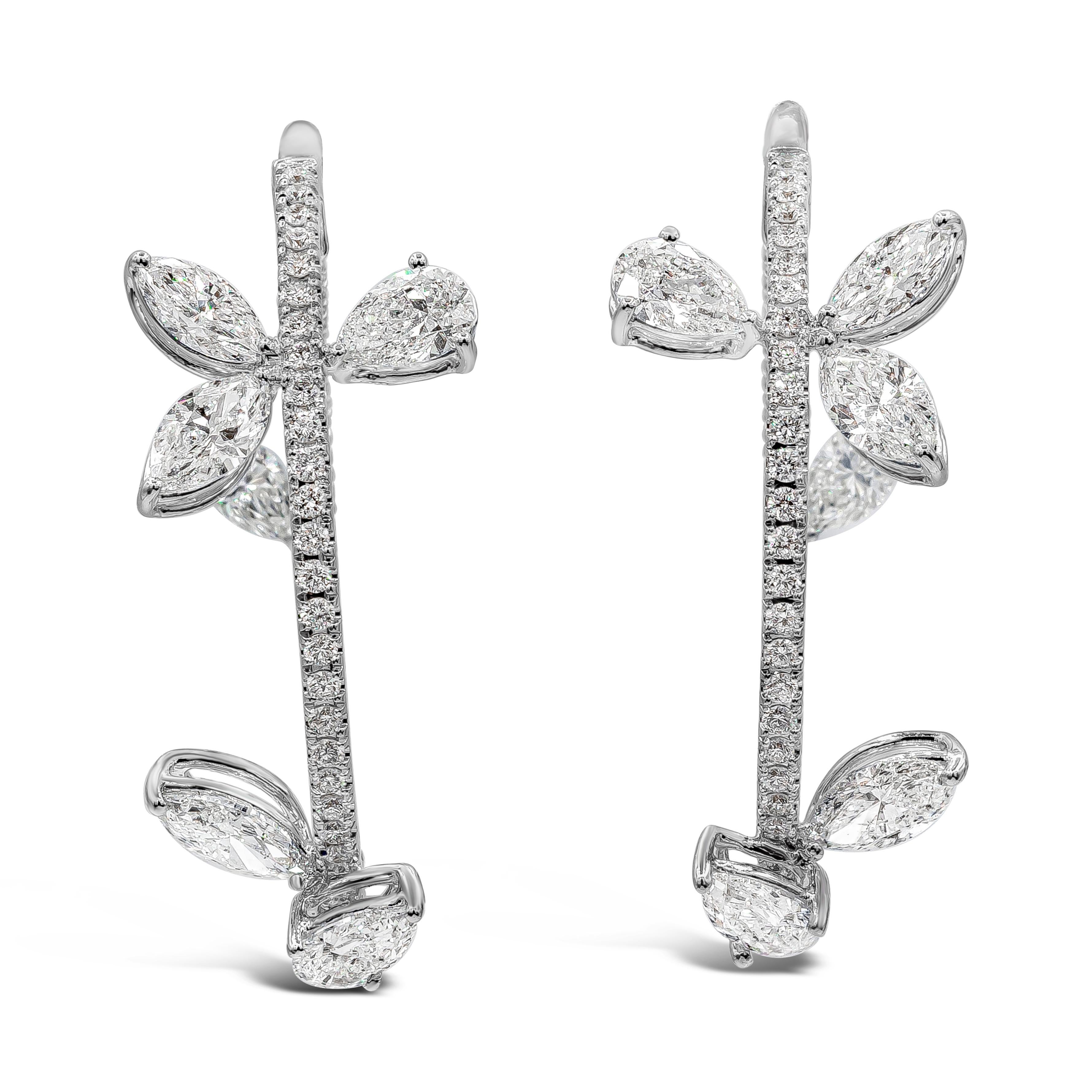 A unique and fashionable pair of hoop earrings showcasing a row of round brilliant diamonds, accented by pear and marquise cut diamonds. Diamonds weigh 4.47 carats total. Made in 18k white gold. 1.25 inch diameter.

Style available in different