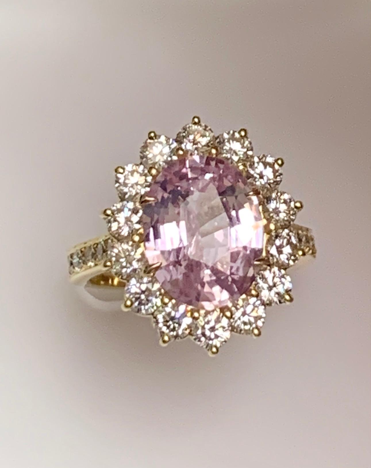4.97 Carat oval pastel color pink sapphire set in 18k yellow gold ring with 1.61 carat round diamonds (G-H SI1) around it and half way on the shank.