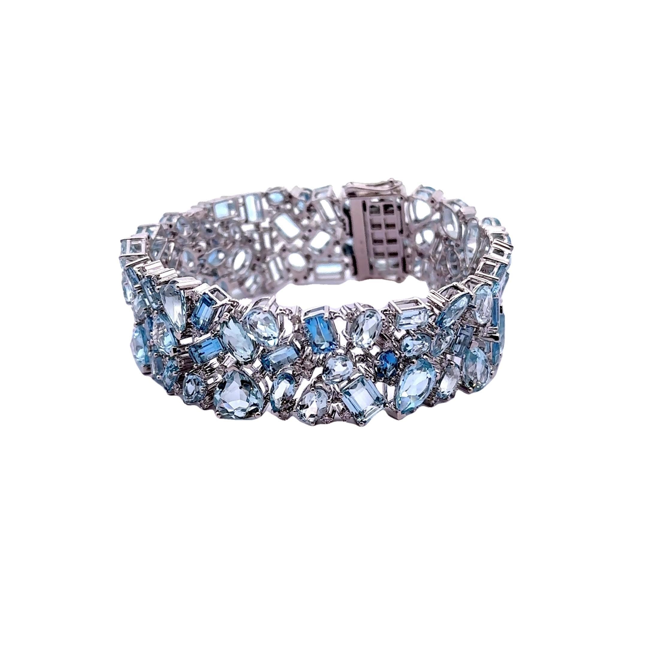 A stunning contemporary bracelet, showcasing a captivating array of aquamarine and diamonds. The bracelet features 44.70 carats of mixed-shape aquamarine, interspersed with 1.46 carats of round brilliant-cut white diamonds that shimmer elegantly.