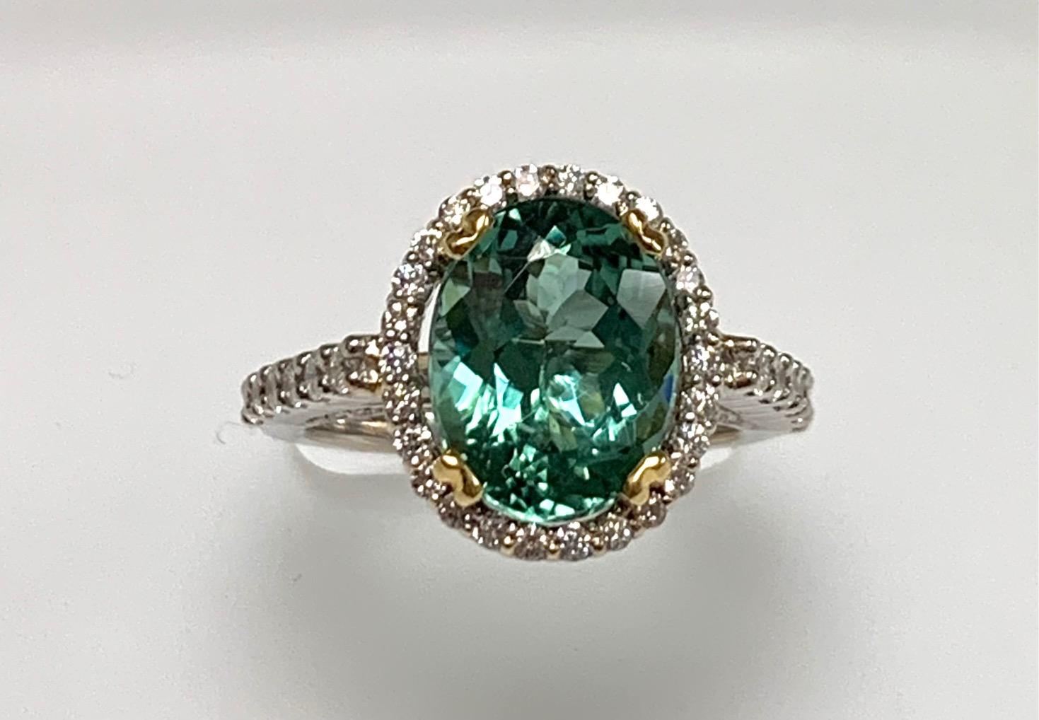 4.48 Carat green tourmaline set in 18k white gold ring along with 0.88 ct diamonds around , under the basket , and half way on the shank.yellow gold basket