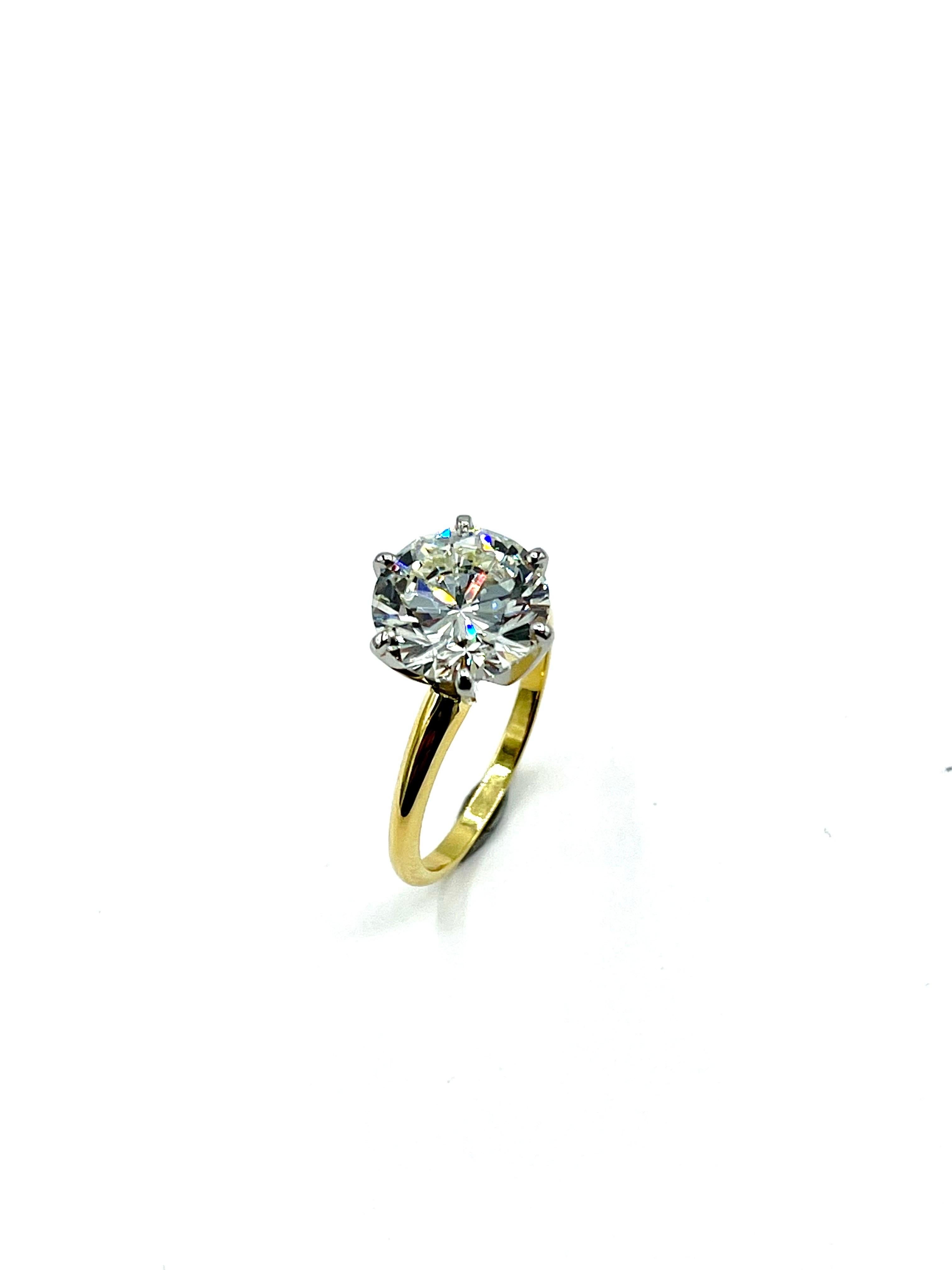 An absolutely stunning round brilliant Diamond solitaire ring.  The Diamond is set in a platinum six prong head on an 18k yellow gold shank.  The Diamond is graded as a J color, SI2 clarity by GIA report number 1226479851, and has excellent fire and