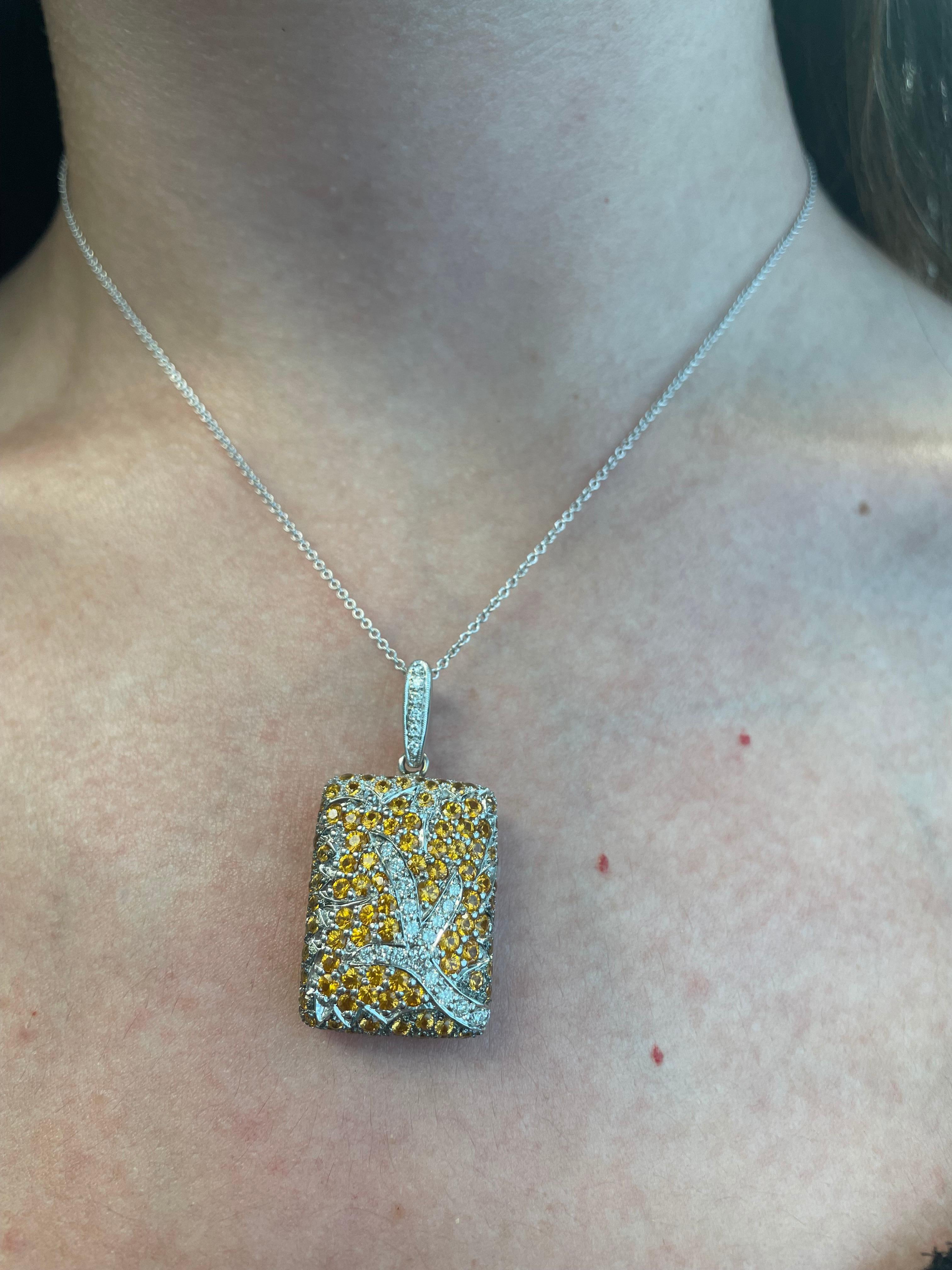 Beautiful tree motif yellow sapphire and diamond necklace pendant. 
4.80 carats of round yellow sapphire. 0.48ct of round brilliant diamonds, approximately G/H color and SI clarity. 18-karat white gold.
Accommodated with an up-to-date digital