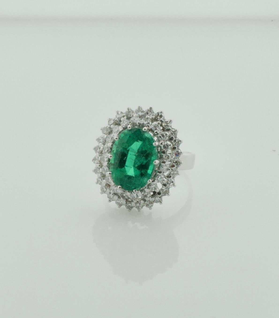 4.49 carat Emerald and Diamond Ring in 18k with G.I.A. Certificate
One Oval Emerald  weighing 4.49 carats 
Forty Seven Round Cut Diamonds weighing 1.05 carats approximately [GHI  VVS- SI1]
Currently Size 6.5 Can Be Sized By Us Or Your Qualified