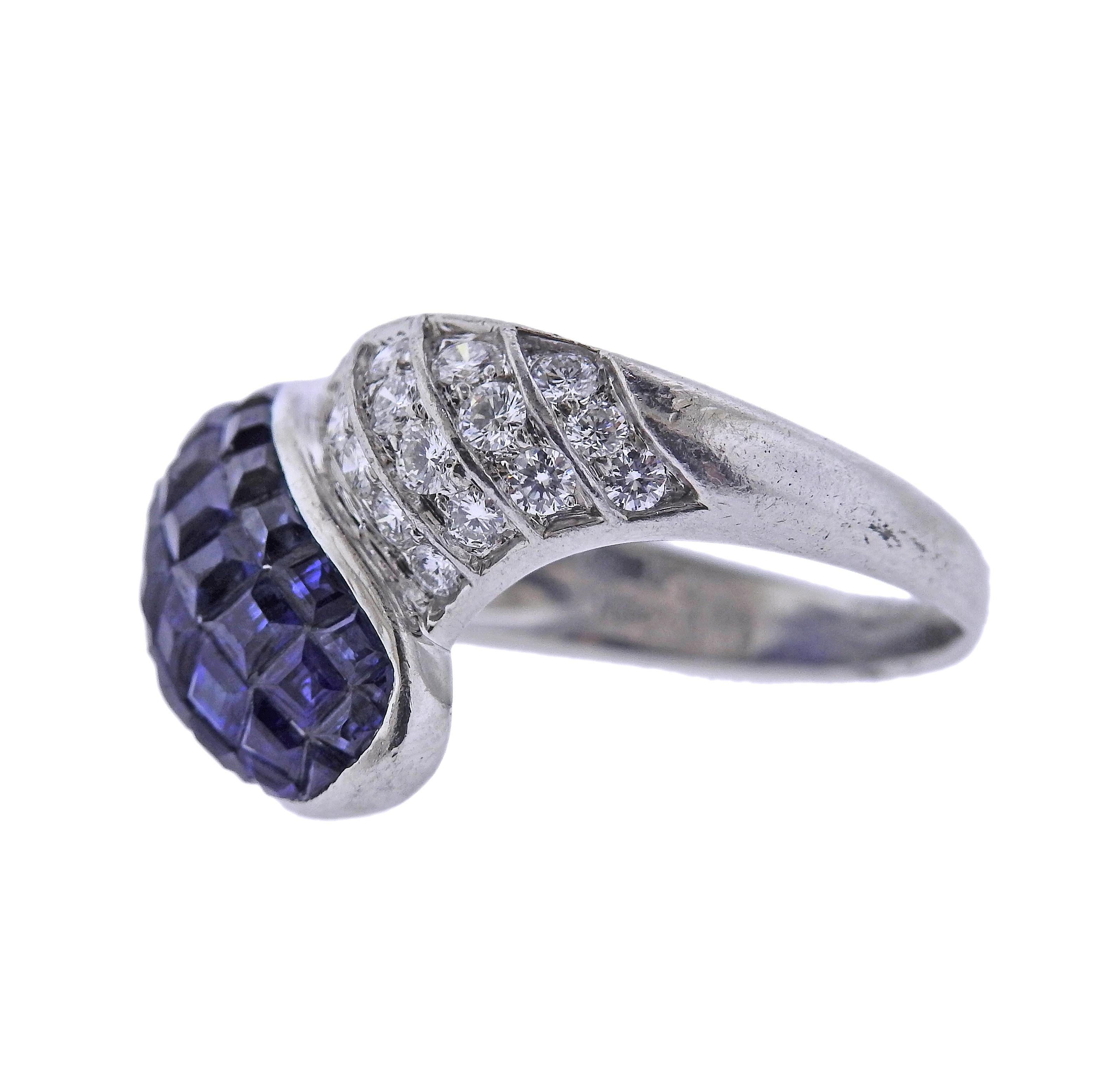 Platinum cocktail ring, featuring 4.49ctw invisible set blue sapphires (few minor chips on multiple stones are present) and 0.50ctw H/VS diamonds. Ring size - 9, ring top is 15mm wide. Marked: pt900, 4.49, 0.50. Weight - 12 grams.