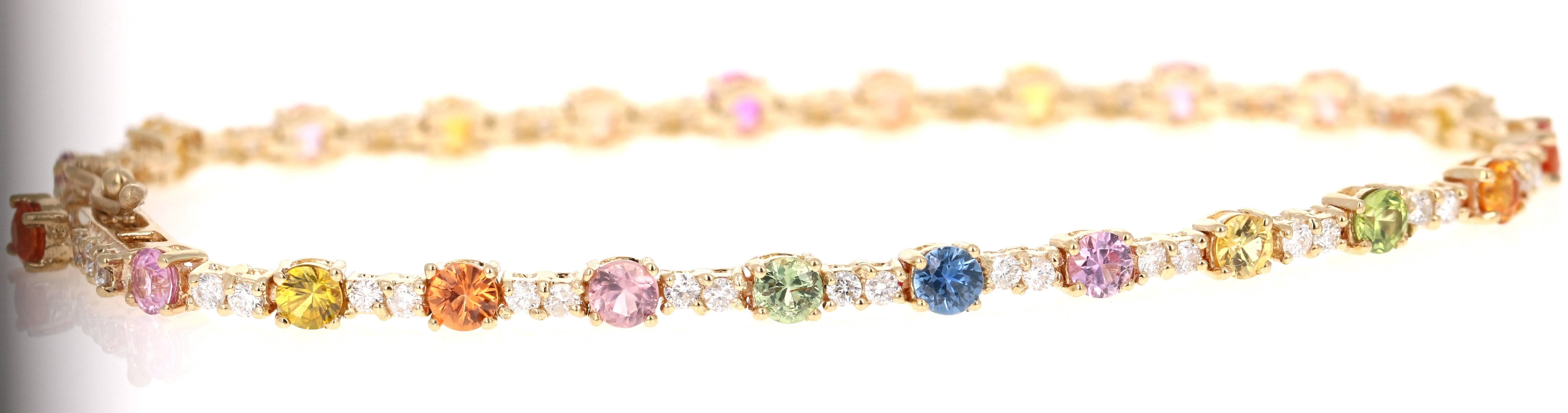 Beautifully designed 4.49 Carat Multi-Colored Sapphire and Diamond Yellow Gold Tennis Bracelet.  This gorgeous piece has 23 Round Cut Multi-Colored Sapphires that weigh 3.63 Carats and 47 Round Cut Diamonds that weigh 0.86 carats The clarity and