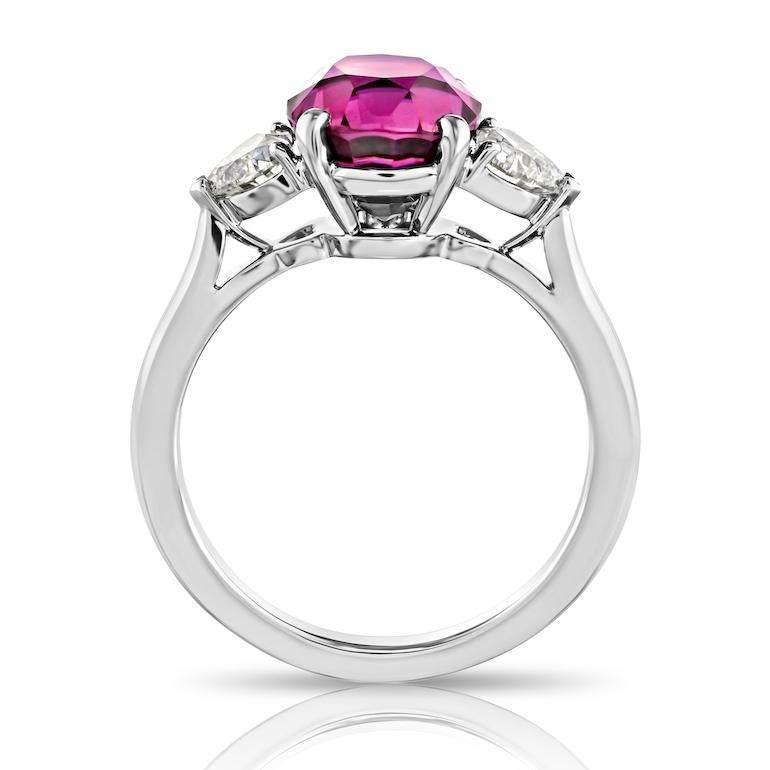 Contemporary 4.49 carat Oval Pink Sapphire with two Heart Diamonds in a Platinum ring For Sale