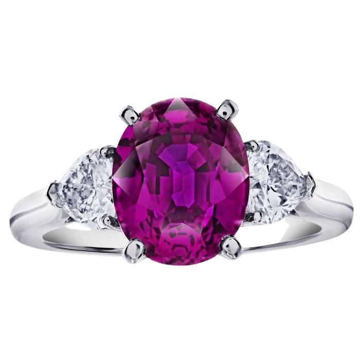 4.49 carat Oval Pink Sapphire with two Heart Diamonds in a Platinum ring