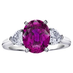 4.49 carat Oval Pink Sapphire with two Heart Diamonds in a Platinum ring