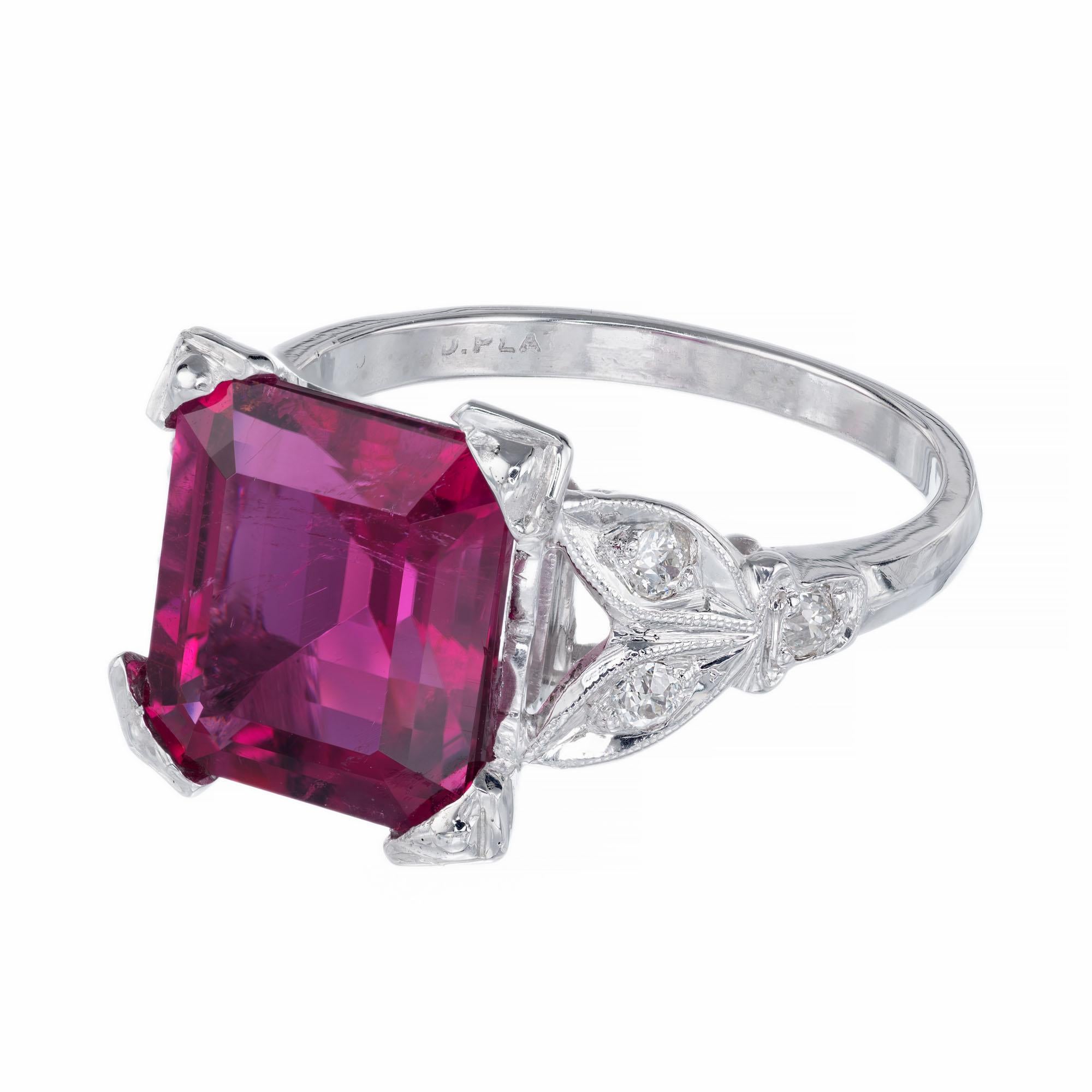 Bright red rubellite tourmaline and diamond Art Deco ring. 4.49ct emerald cut center stone with 6 round old European cut accent diamonds in a platinum setting from teh 1920's. 

1 reddish pink rectangular step cut rubellite tourmaline, approx.