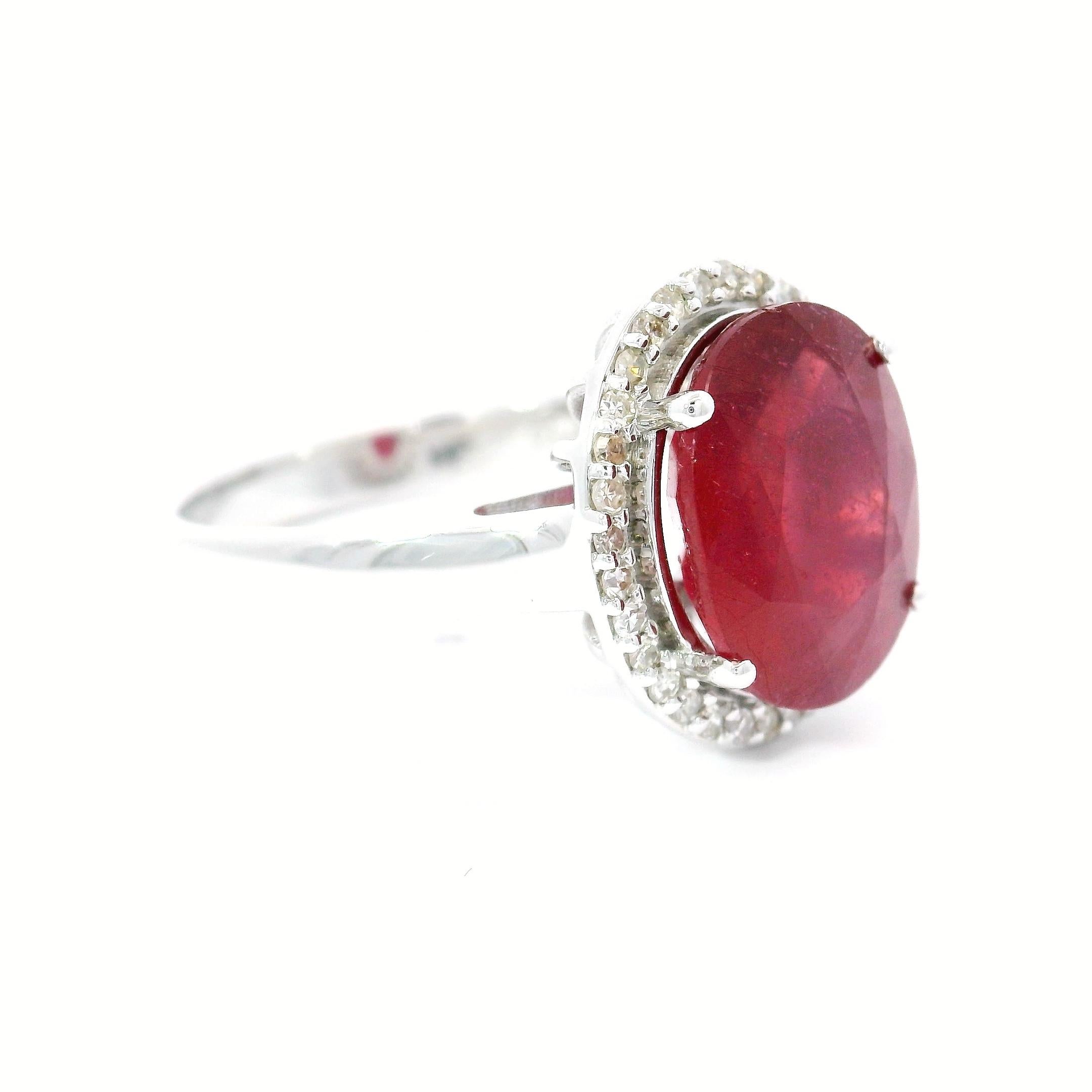 18kt white gold Ruby Ring
  
  Gold colour & karat: White gold 18kt
  Weight: 5.52 grams
  
  Set with-
  Stone type: Ruby 
  Shape: Oval
  Carat: 4.49 ct
  Colour: Red ruby 
  
  Surrounding Stones: Diamonds
 1) White Diamonds
  Carat weight: 0.16