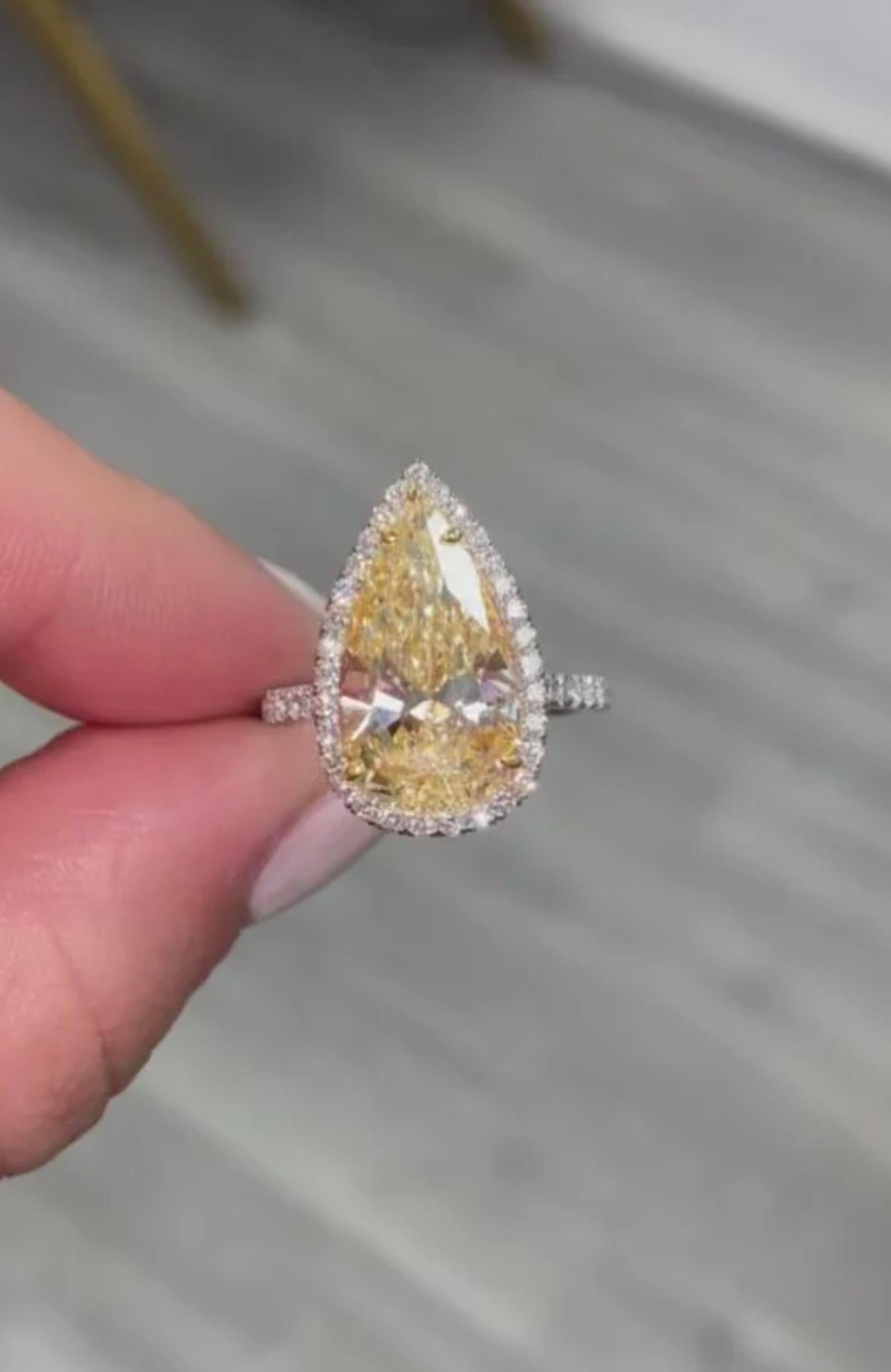 •4.49 Carat GIA Pear Shape, 
Light Yellow, W-X Color
•VS1 Clarity 
•Massive look! 16 millimeter length, on par with 6 and 7 carats pears!
•Handmade platinum ring with yellow gold and a white diamond halo 
This piece can be viewed before purchase in