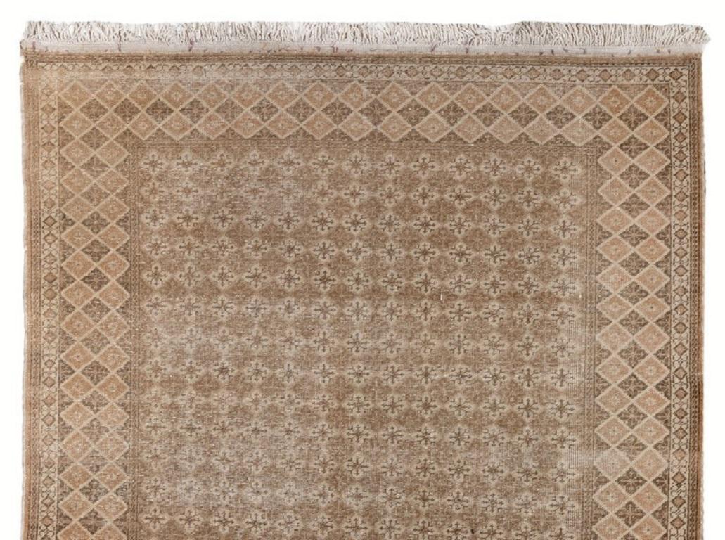A hand-knotted vintage Turkish accent rug in muted Colors.
It is made of wool on cotton foundation, is in very good condition, sturdy and clean as a brand new rug. Measures: 4.4 x 7 ft.
