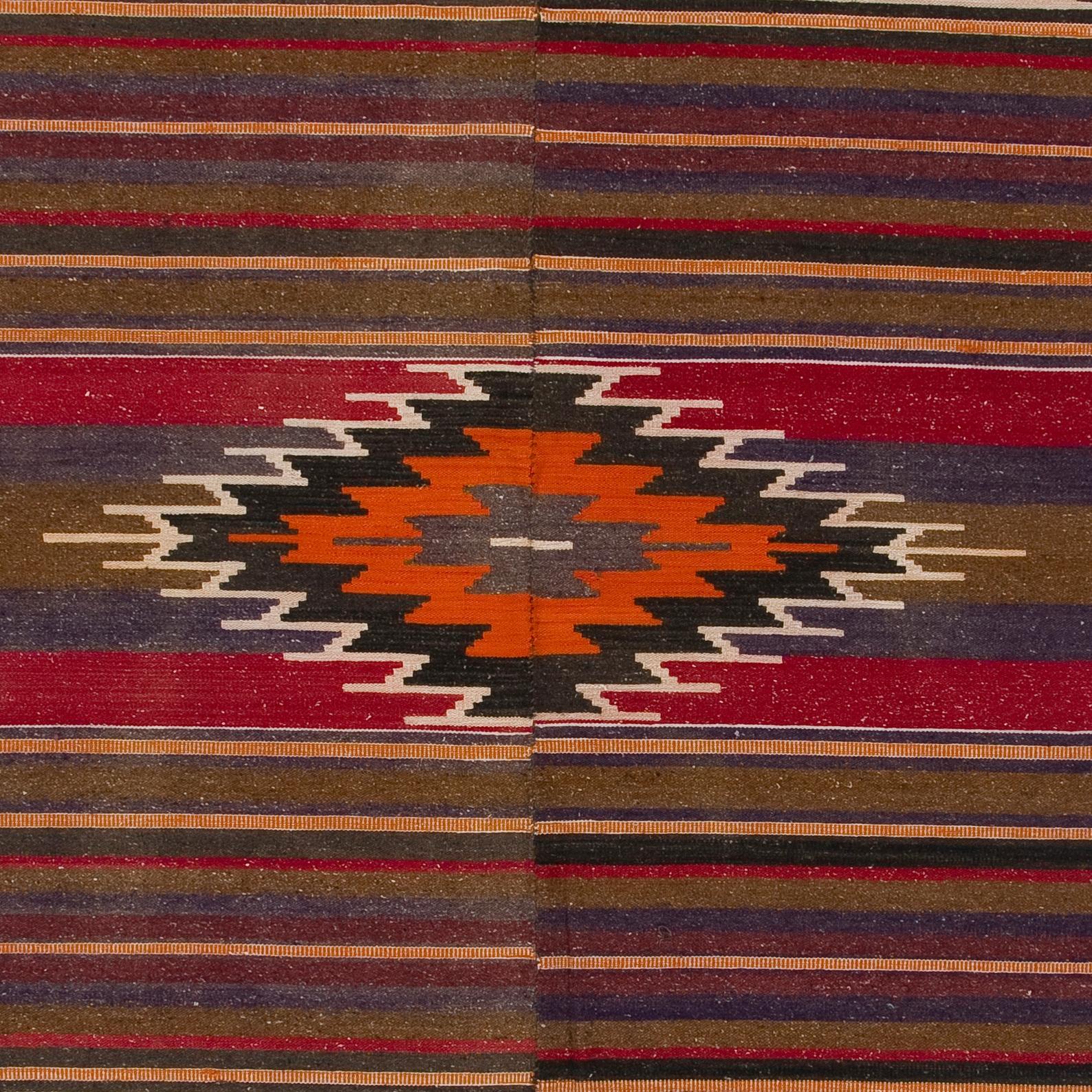A simple yet beautiful wool rug handwoven by the Nomadic tribes in South Central Turkey. Very good condition, sturdy and clean. 100% wool. This Kilim is traditionally woven in two halves and connected in the center. 
Size: 4.4 x 9 ft.