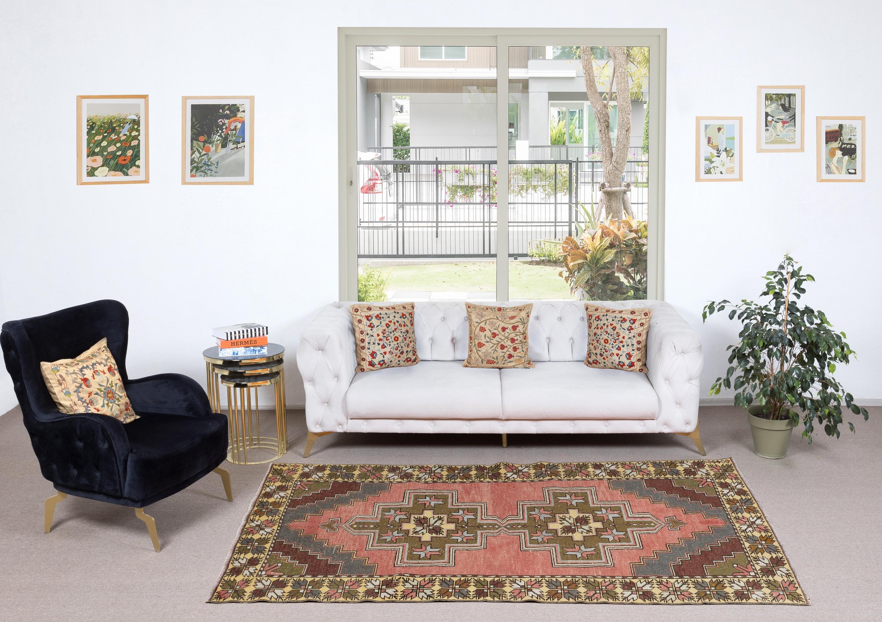 Add a touch of timeless elegance to your home with this traditional vintage hand knotted Turkish area rug, crafted from 100% premium wool. This exquisite piece captures the essence of traditional Anatolian craftsmanship, featuring intricate patterns