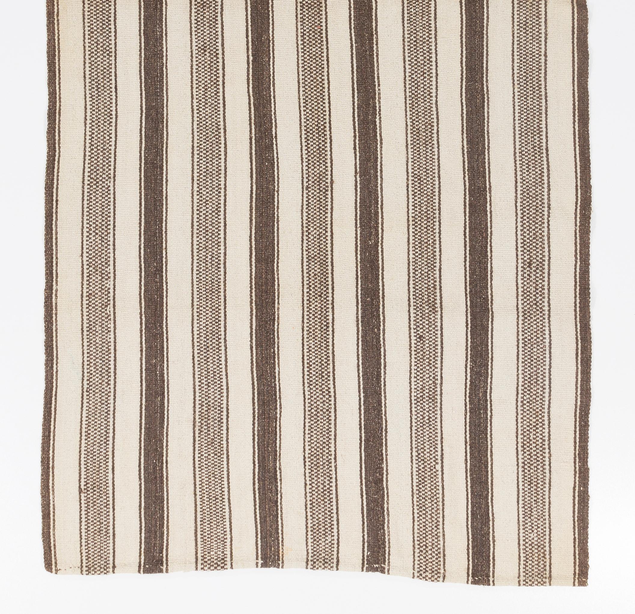 This simple handwoven rug made to be used by the villagers in Central Anatolia. 
100% natural un-dyed wool. Very good condition, sturdy and clean.
Ideal for both residential and commercial interiors. Measures: 4.4 x 9.2 ft.