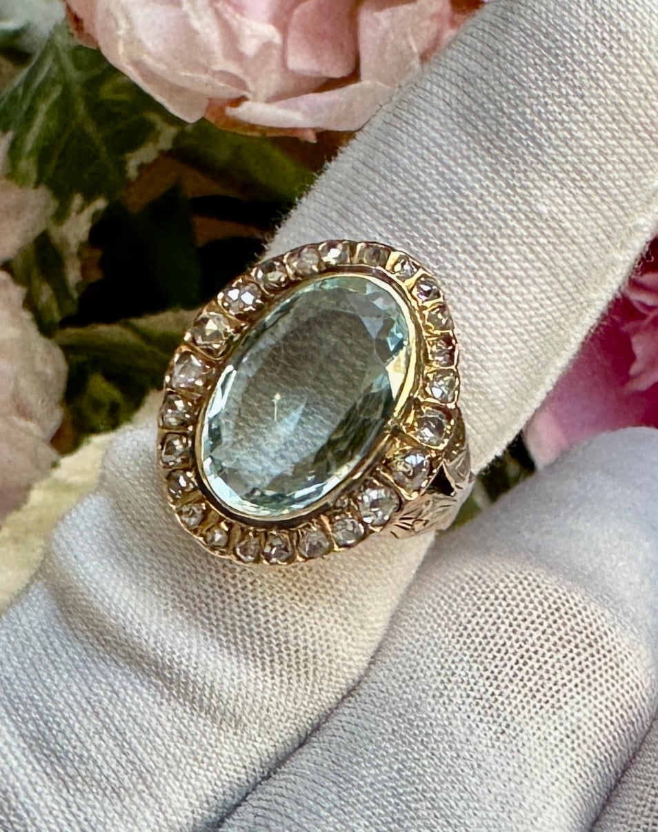 We are so delighted to have this extraordinary 4.5 Carat antique natural Aquamarine Ring with a halo of 24 graduated Rose Cut Diamonds.  The magnificent oval faceted aquamarine is 16mm long, 11mm wide and is approximately 4.5 Carats.  The cut is