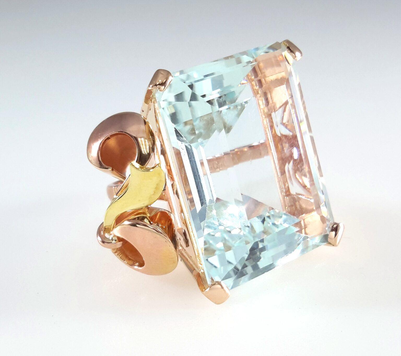 This extraordinary estate ring features a breathtaking 45-carat emerald-cut aquamarine, set in warm 18k rose gold. The aquamarine is crystal clear—so pure it resembles fine glass, with a soft, icy blue hue that captures and reflects light