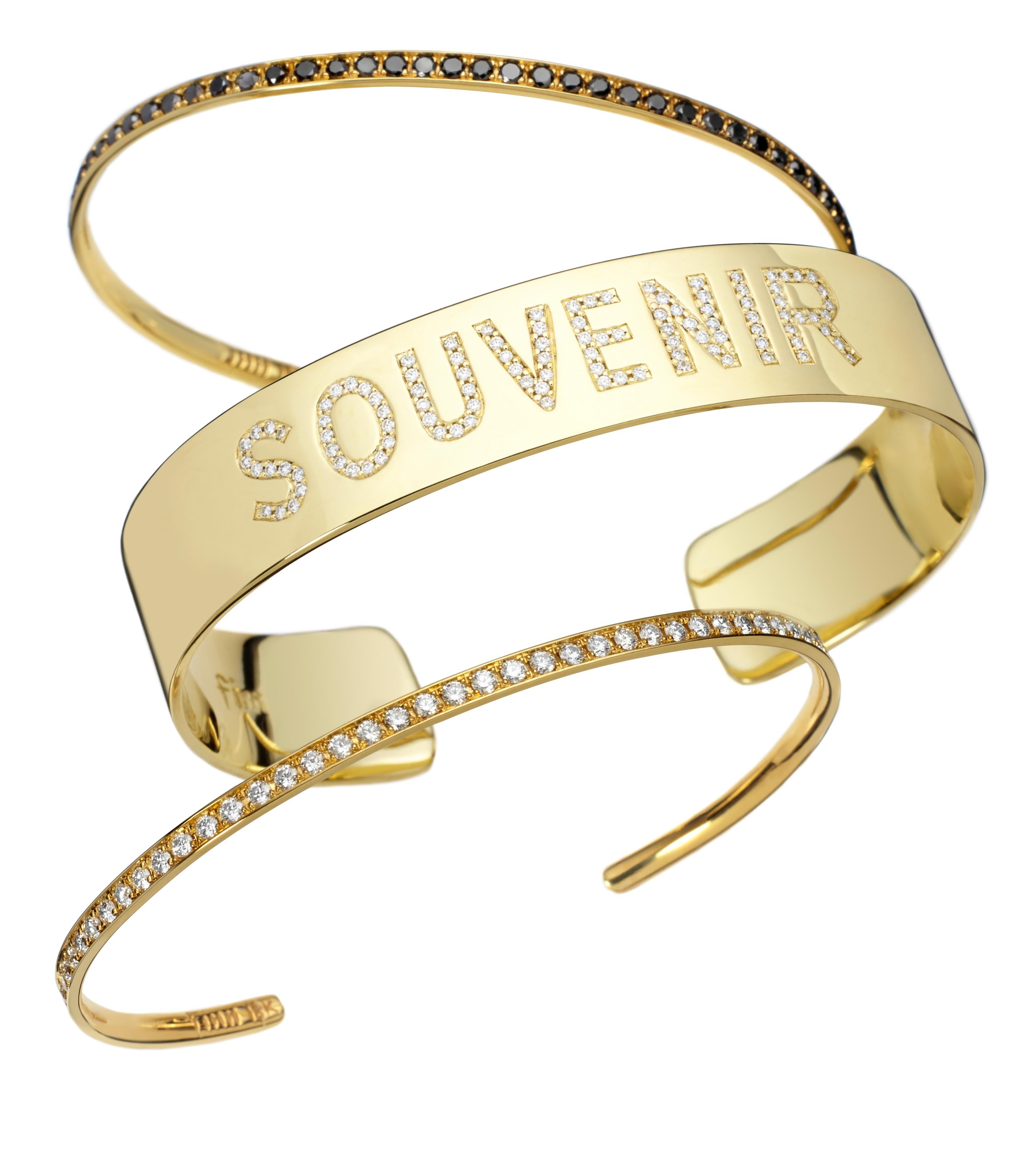 This solid 18k gold cuff bracelet was hand set with white diamonds (.45 ct) spelling the word 