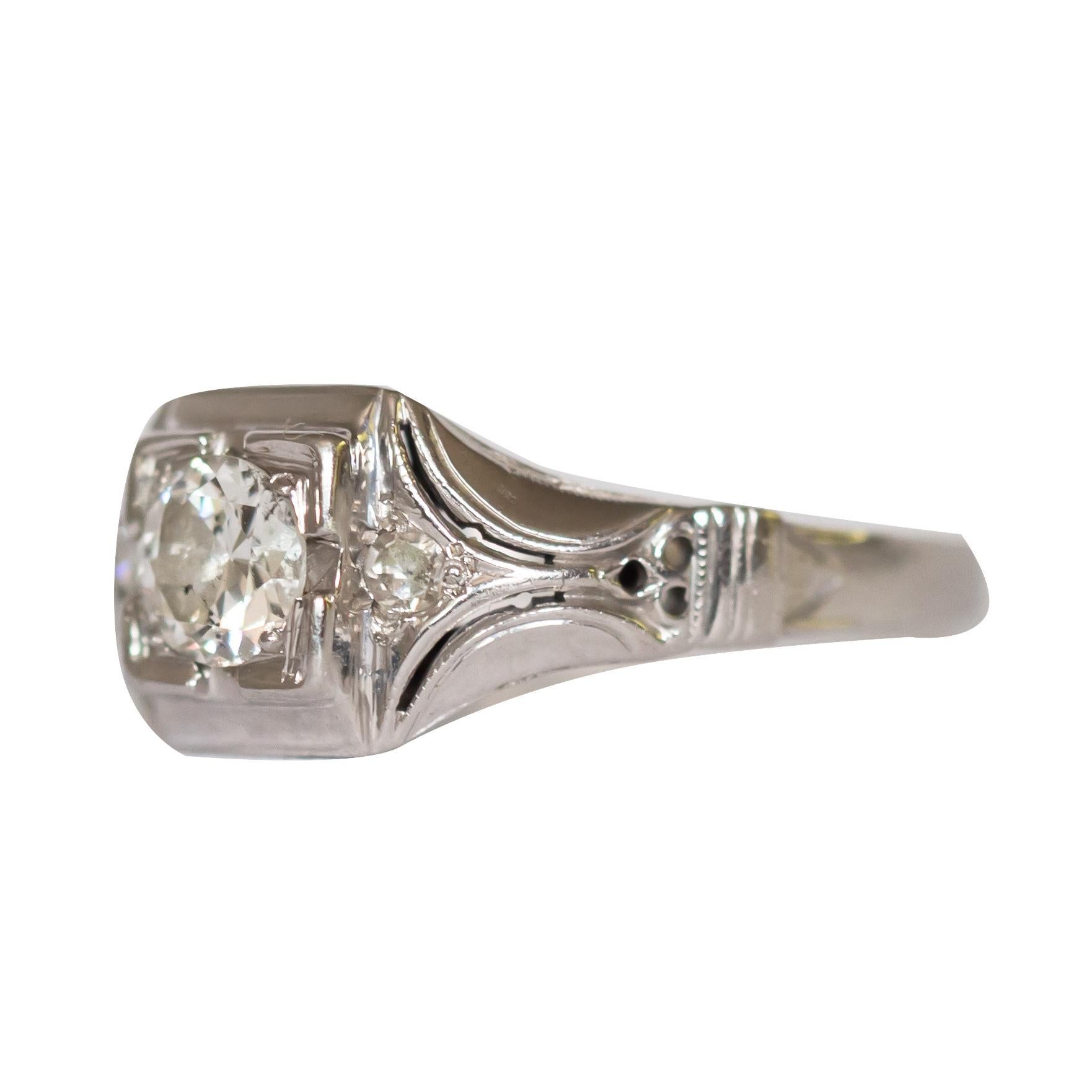 Ring Size: 7
Metal Type: 18 karat White Gold [Hallmarked, and Tested]
Weight: 2.5 grams

Center Diamond Details:
Weight: .45 carat
Cut: Old European
Color: H
Clarity: VS2

Side Diamond Details:
Weight: .06 carat, total weight
Cut: Old