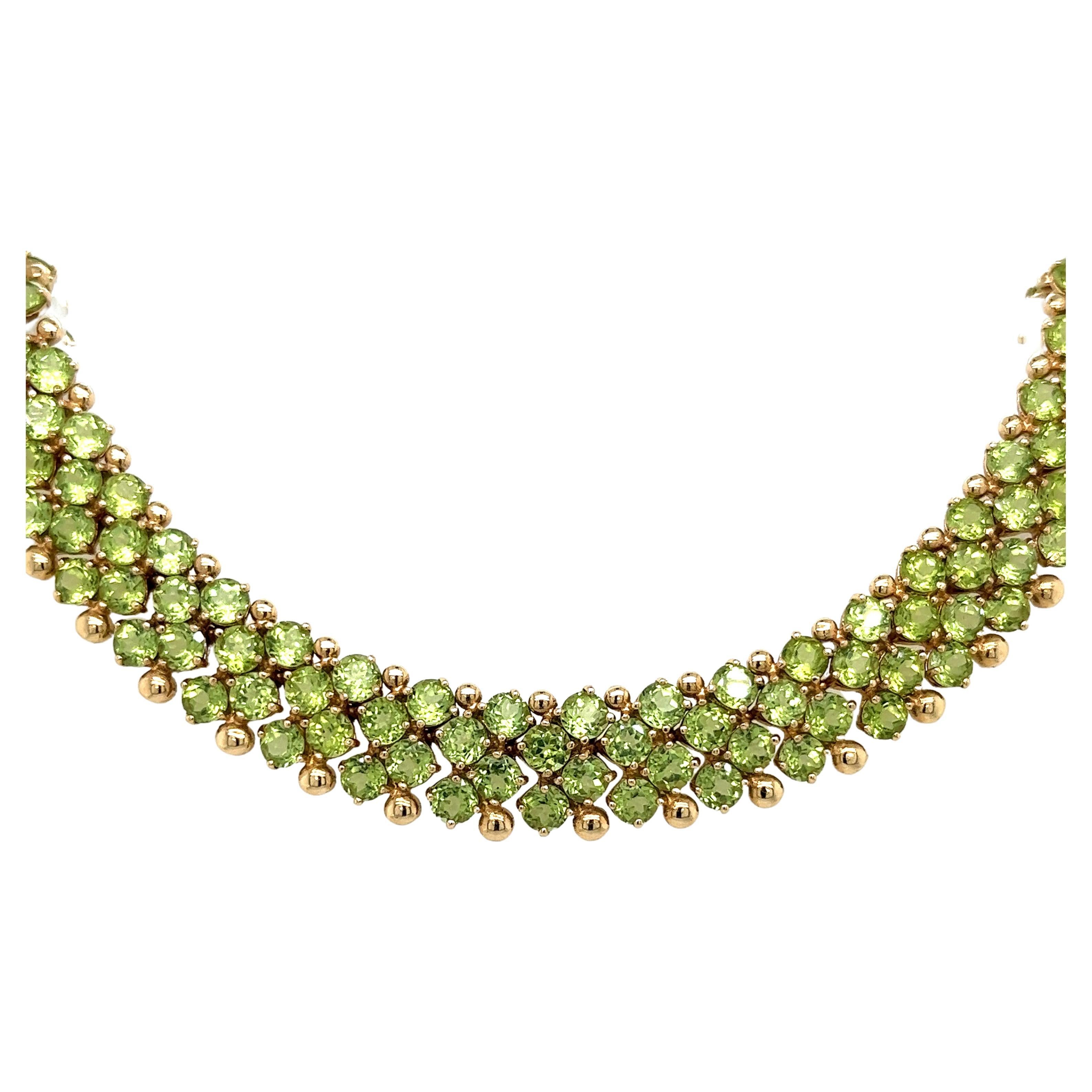 Elevate your style with this breathtaking 45-carat peridot gemstone cluster choker necklace. These natural gemstones are full of brilliance and luster, and are set in a 14-karat shiny yellow gold. This necklace sits beautifully on the neck,