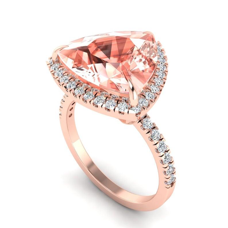 This ring has been meticulously crafted from 14-karat gold and hand set with 4.5 carats morganite and .72 carats of sparkling diamonds. Available in rose, white and yellow gold.

The ring is a size 7 and may be resized to larger or smaller upon