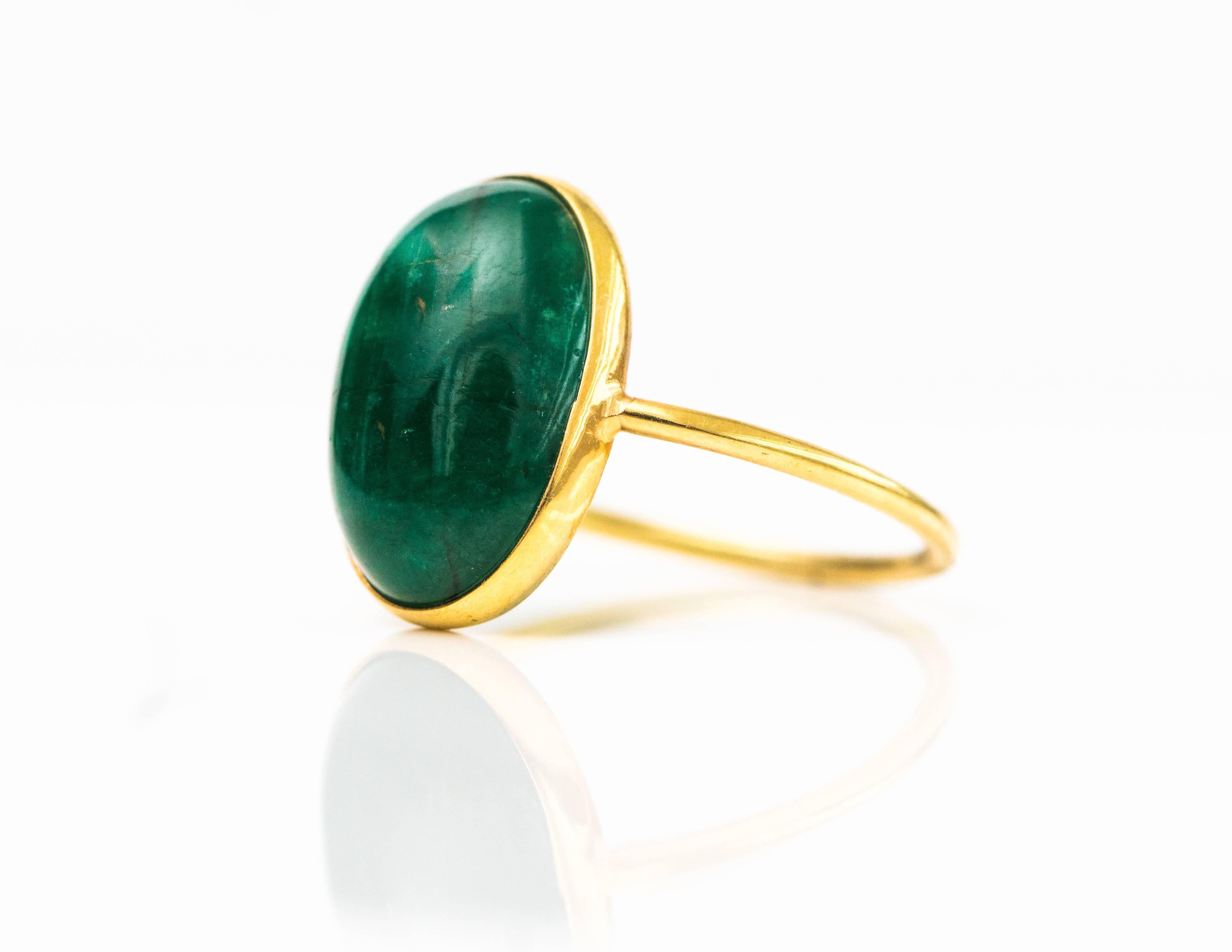 4.5 Carat Oval South American Emerald Ring - 18 Karat Yellow Gold, Emerald

Features an oval Emerald cabochon bezel set in 18 Karat Yellow Gold. This South American Emerald has a luxurious, dark forest green color. This gorgeous deep green Emerald