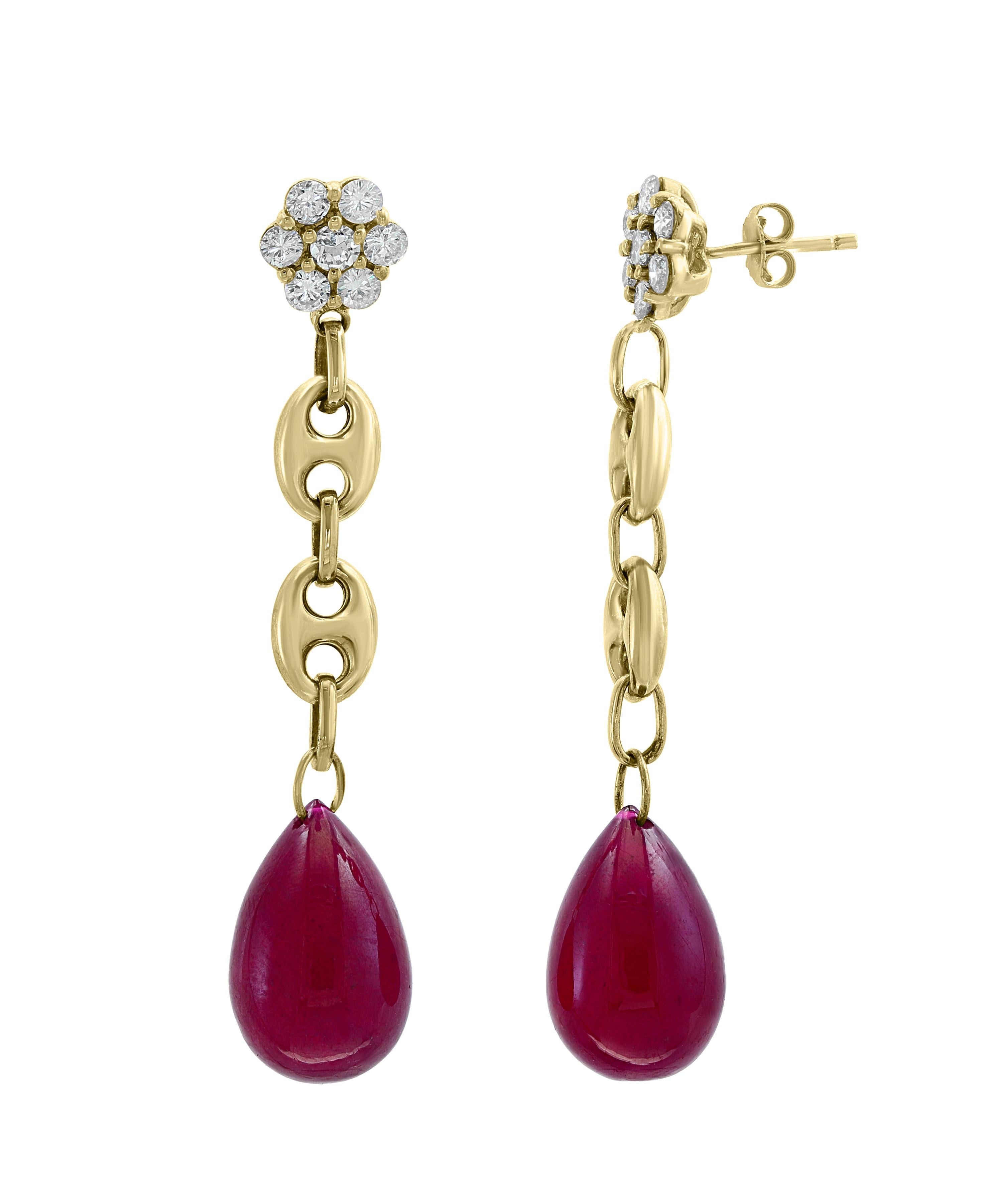 45 Carats  of two  Ruby  drops and Diamond  Hanging Earrings 14 K Yellow Gold
This exquisite pair of earrings are beautifully crafted with 14 karat Yellow gold  weighing    
 15 grams
One large drop of Ruby approximately 23 ct each  Hanging at the 