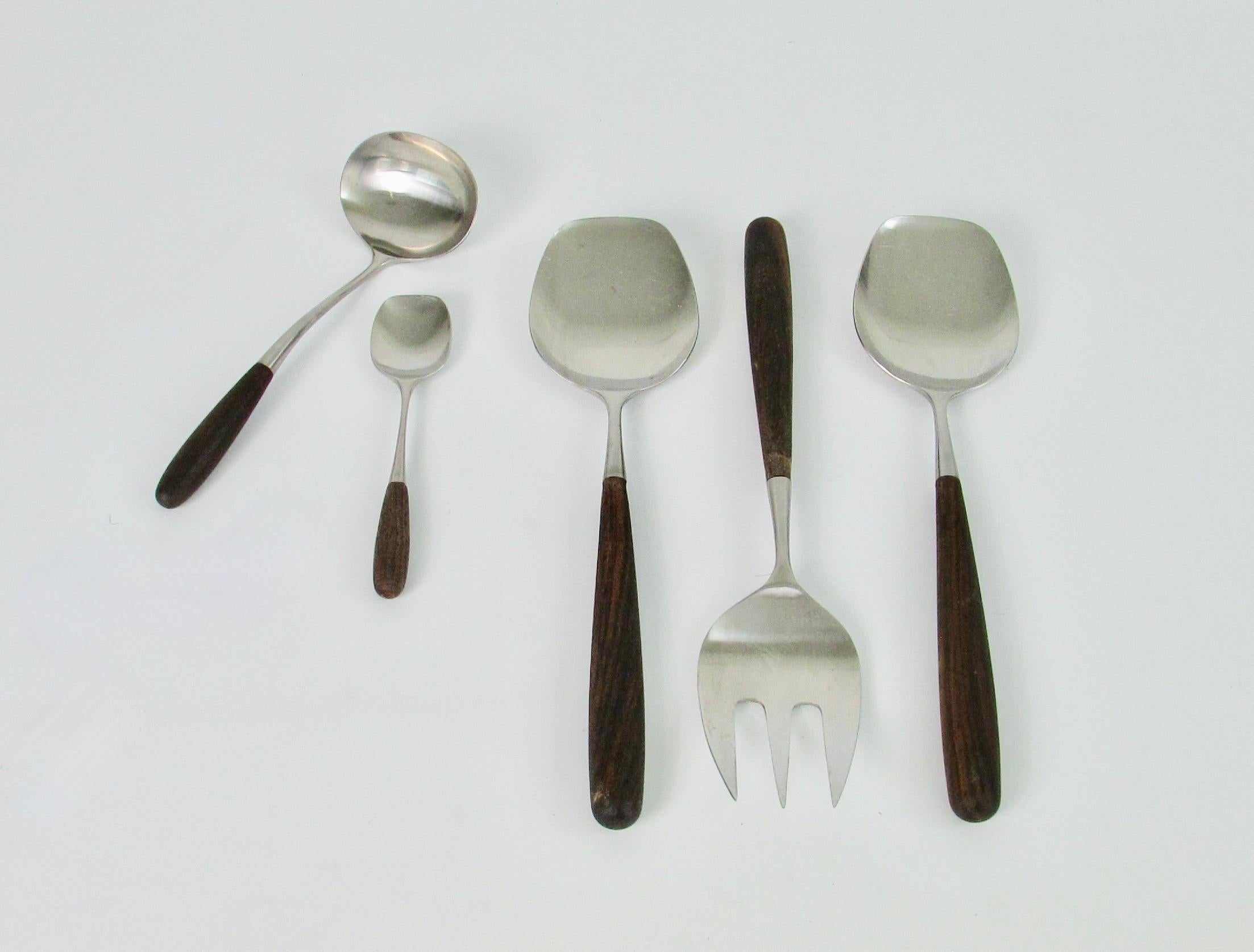 Fine large set of Lauffer Japan stainless steel flatware. Rosewood handles also in fine condition. Included are large spoon with large fork as salad servers, second large spoon, ladle. and sugar spoon. Soup spoon measures 7 3/8