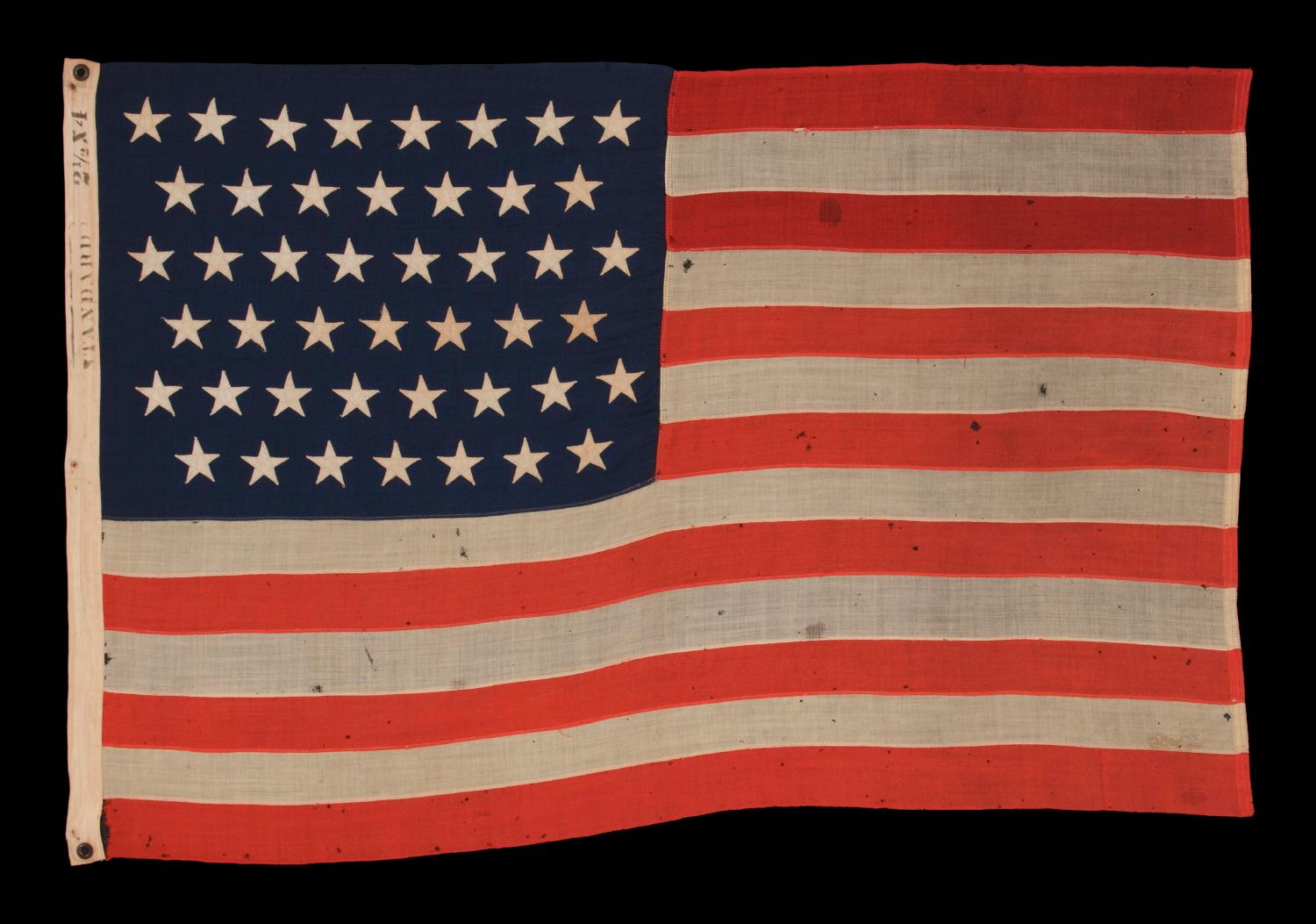 45 STARS ON AN ANTIQUE AMERICAN AMERICAN FLAG IN AN EXTREMELY SMALL SCALE AMONG EXAMPLES OF THE PERIOD WITH PIECED-AND-SEWN CONSTRUCTION, 1896-1907, SPANISH-AMERICAN WAR ERA, REFLECTS UTAH STATEHOOD

45 star American national flag, made in the